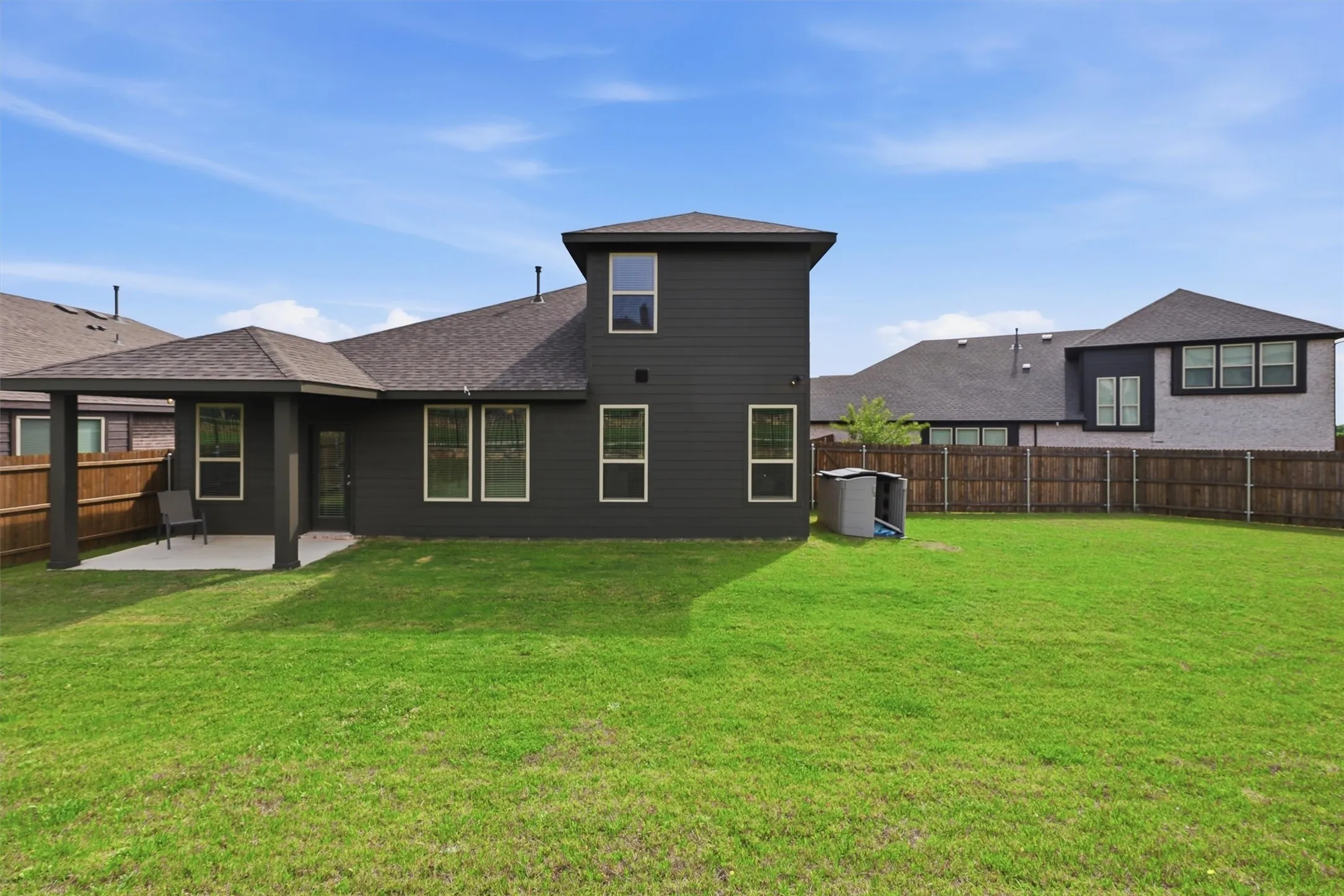 A deep, intergrated covered patio offers a shaded retreat for relaxing or dining alfresco, seamlessly extending your living space outdoors. The vast, fully fenced yard provides a safe and private playground with more than enough room for a future pool, garden, or play set.
