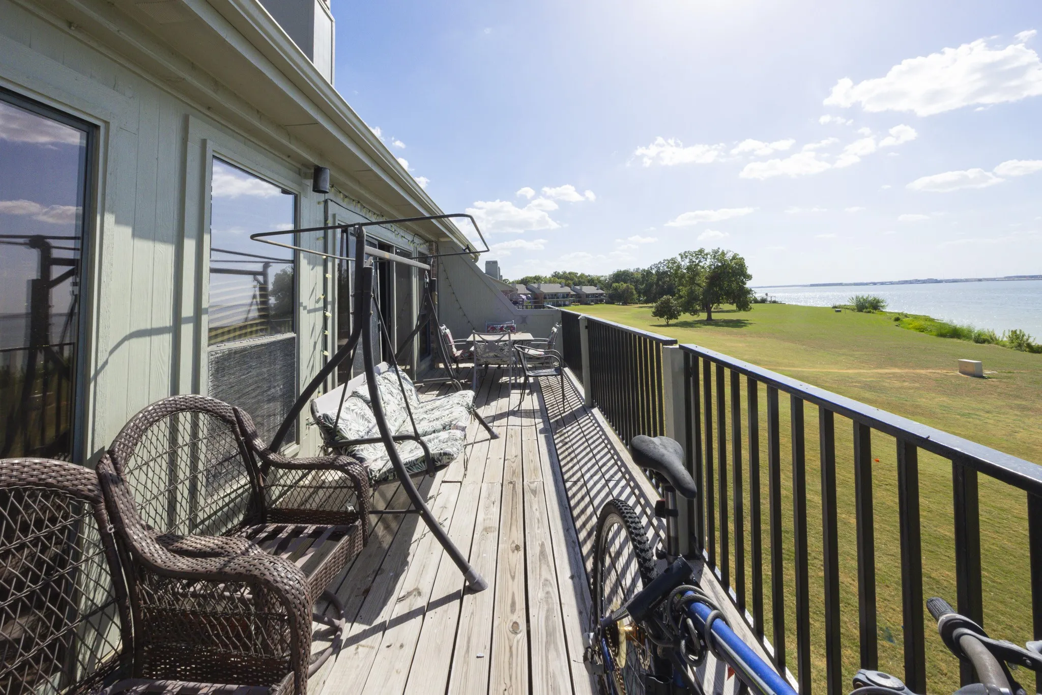 Expansive wood-finish deck with black metal railings