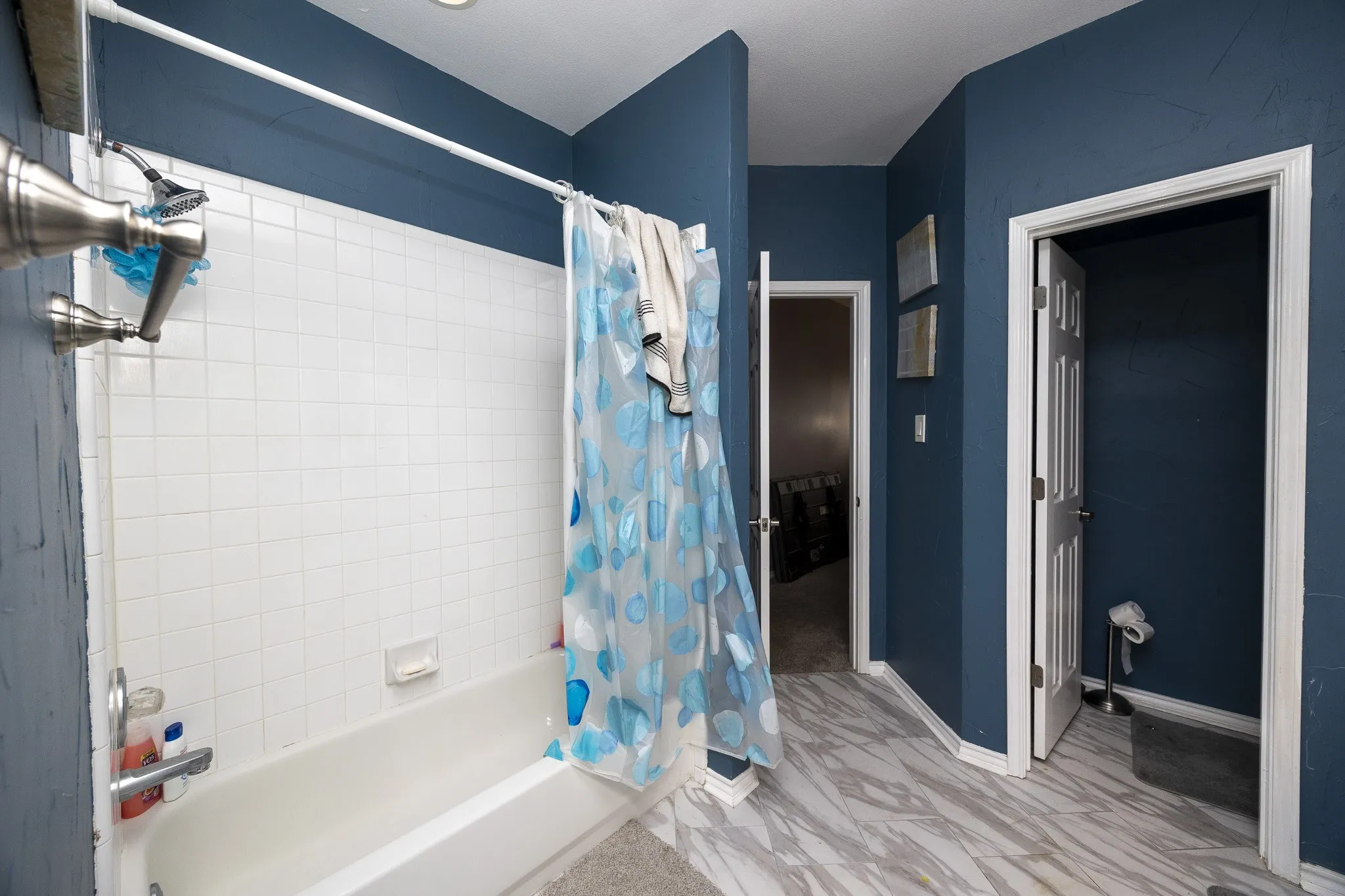 White subway tile shower surround with a built-in tub
