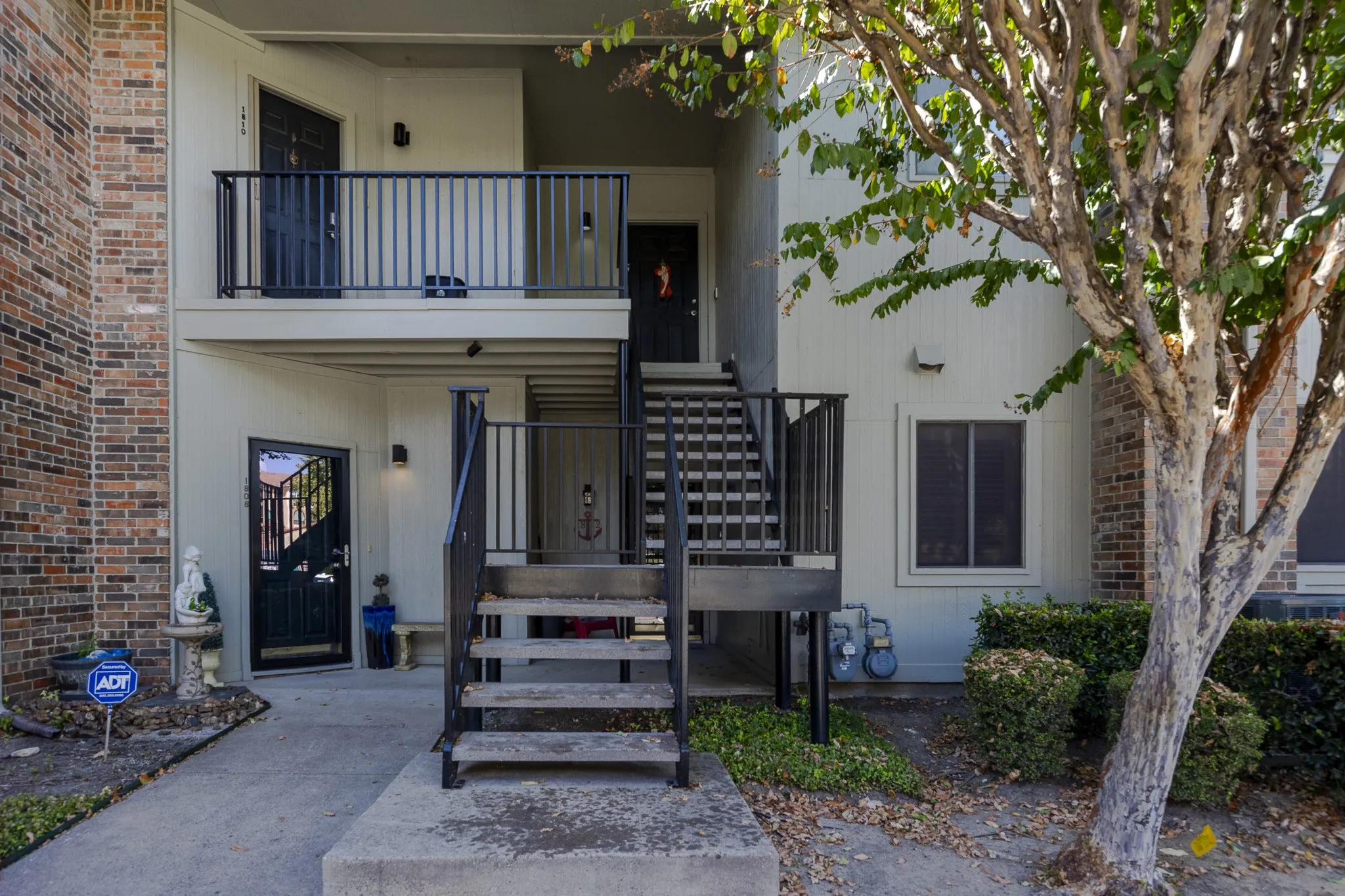 Brick and siding exterior with black metal railings