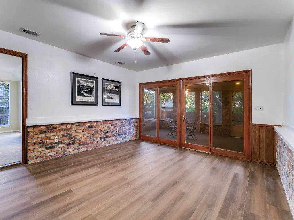 2nd Living space has wall of windows looking out to the screened-in porch.