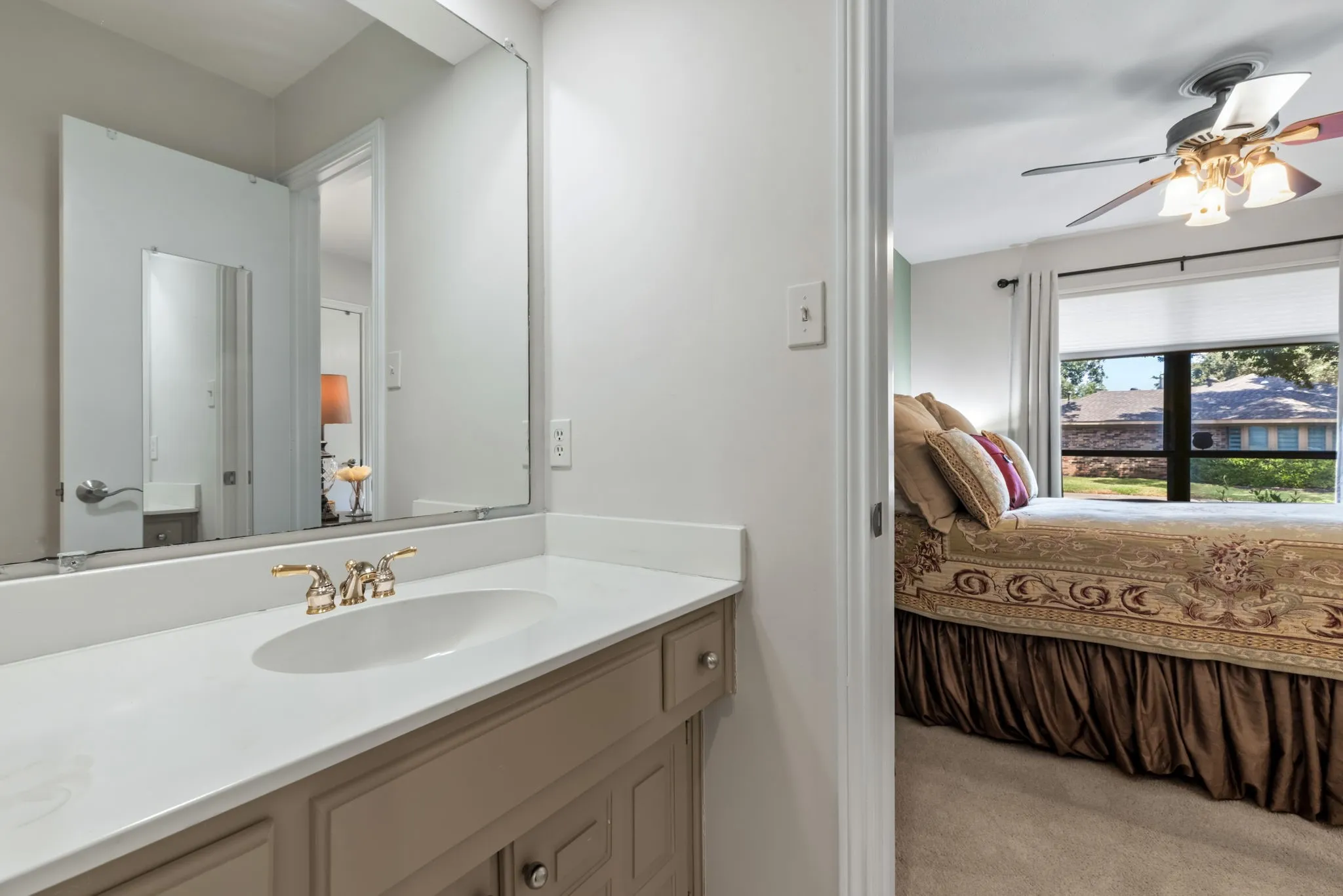 Vanity with integrated sink and brass-finish faucet