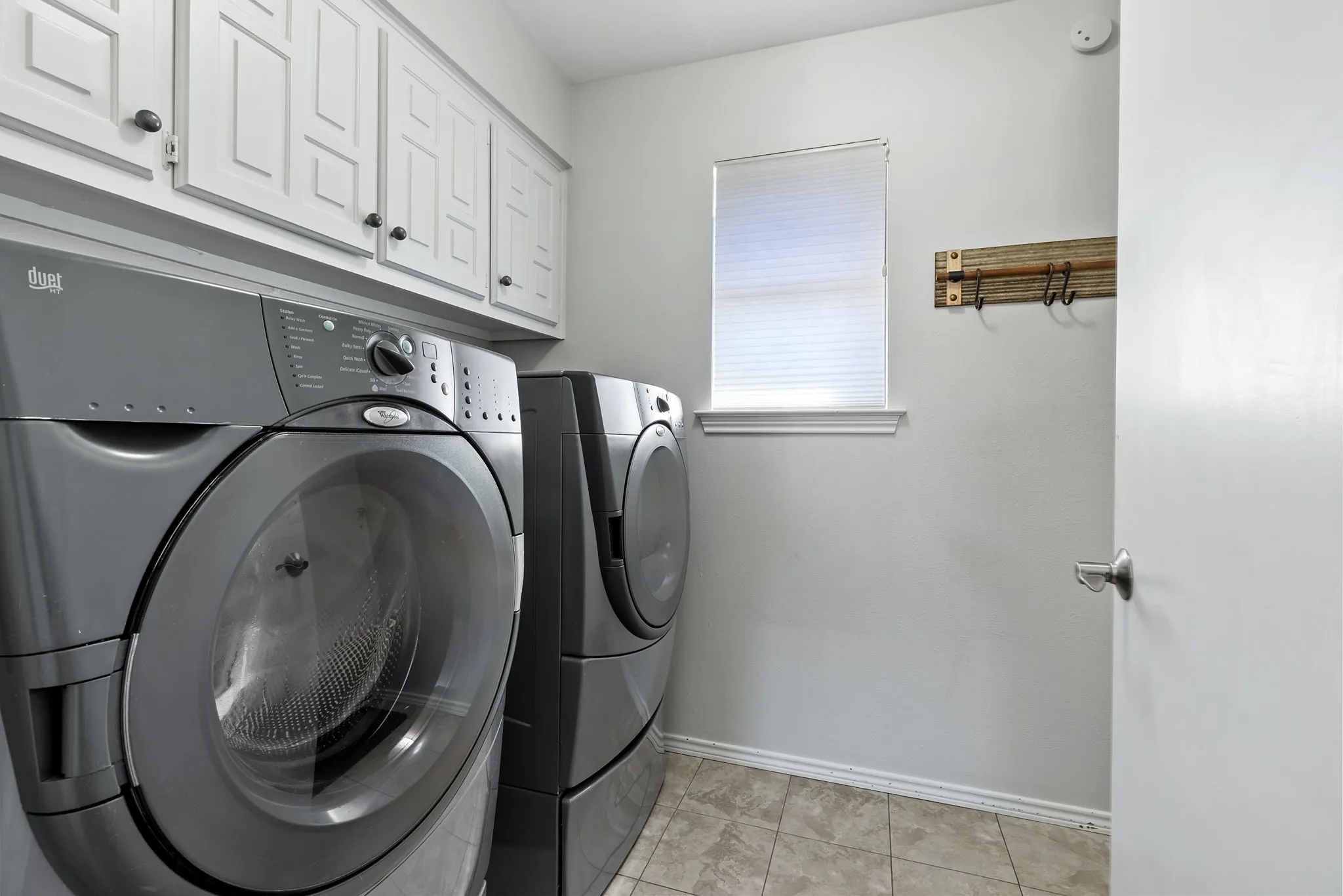 White upper cabinetry with dark hardware