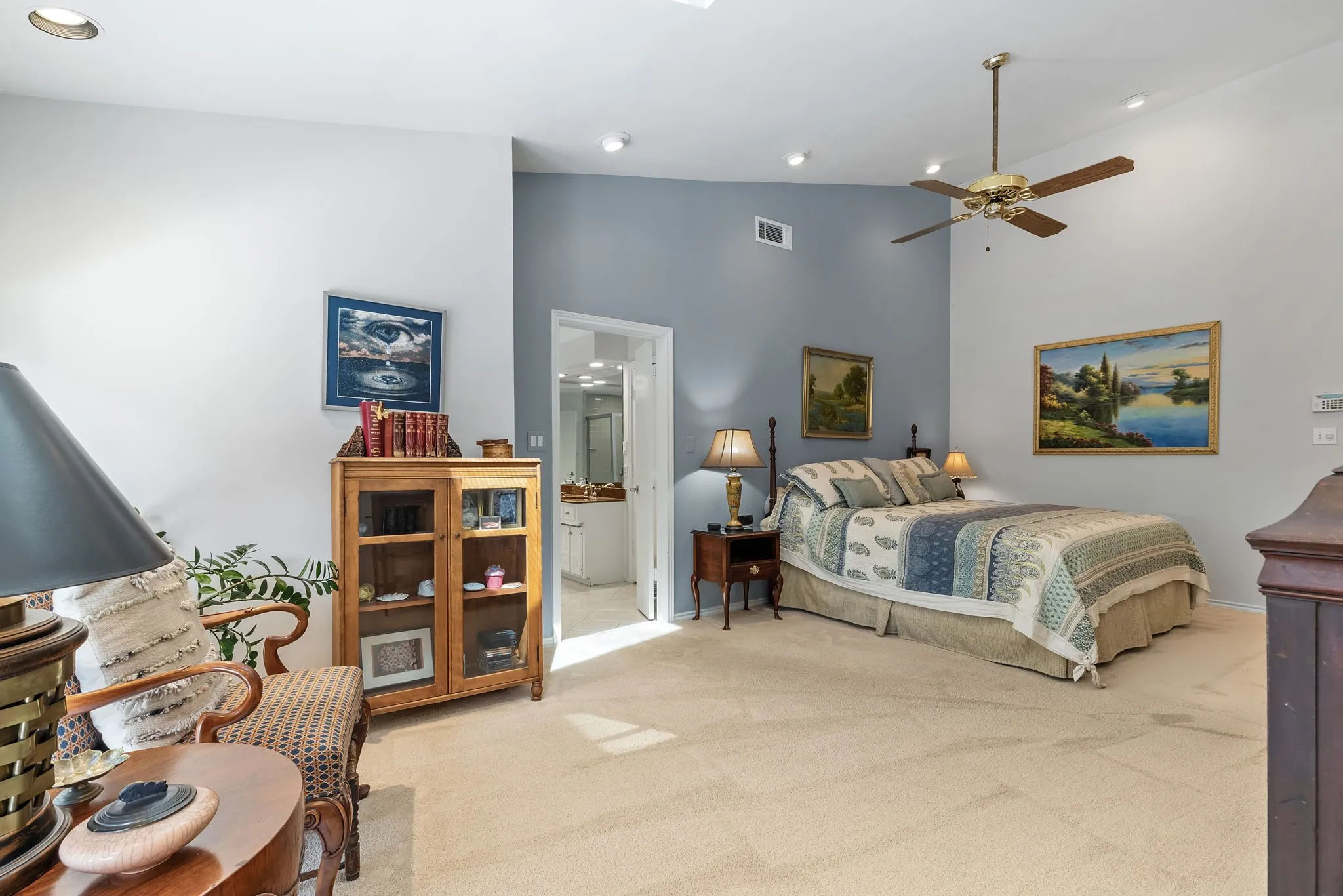 Vaulted ceiling with recessed lighting, ceiling fan, and carpeted flooring