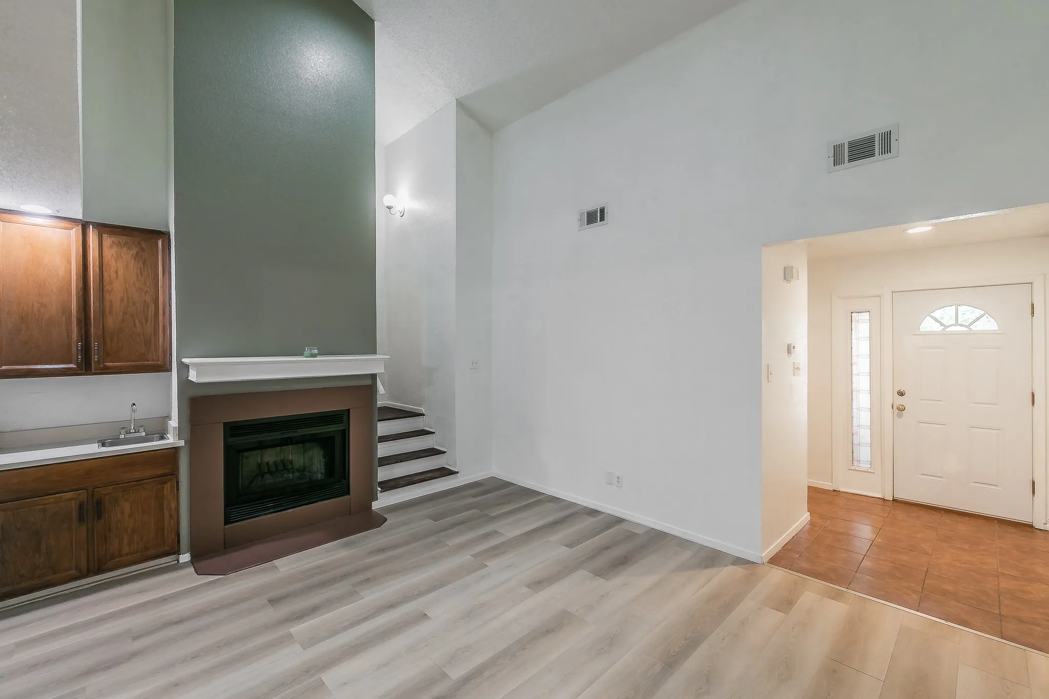 High ceilings , open concept layout with dinning area. Wet bar next to fireplace.