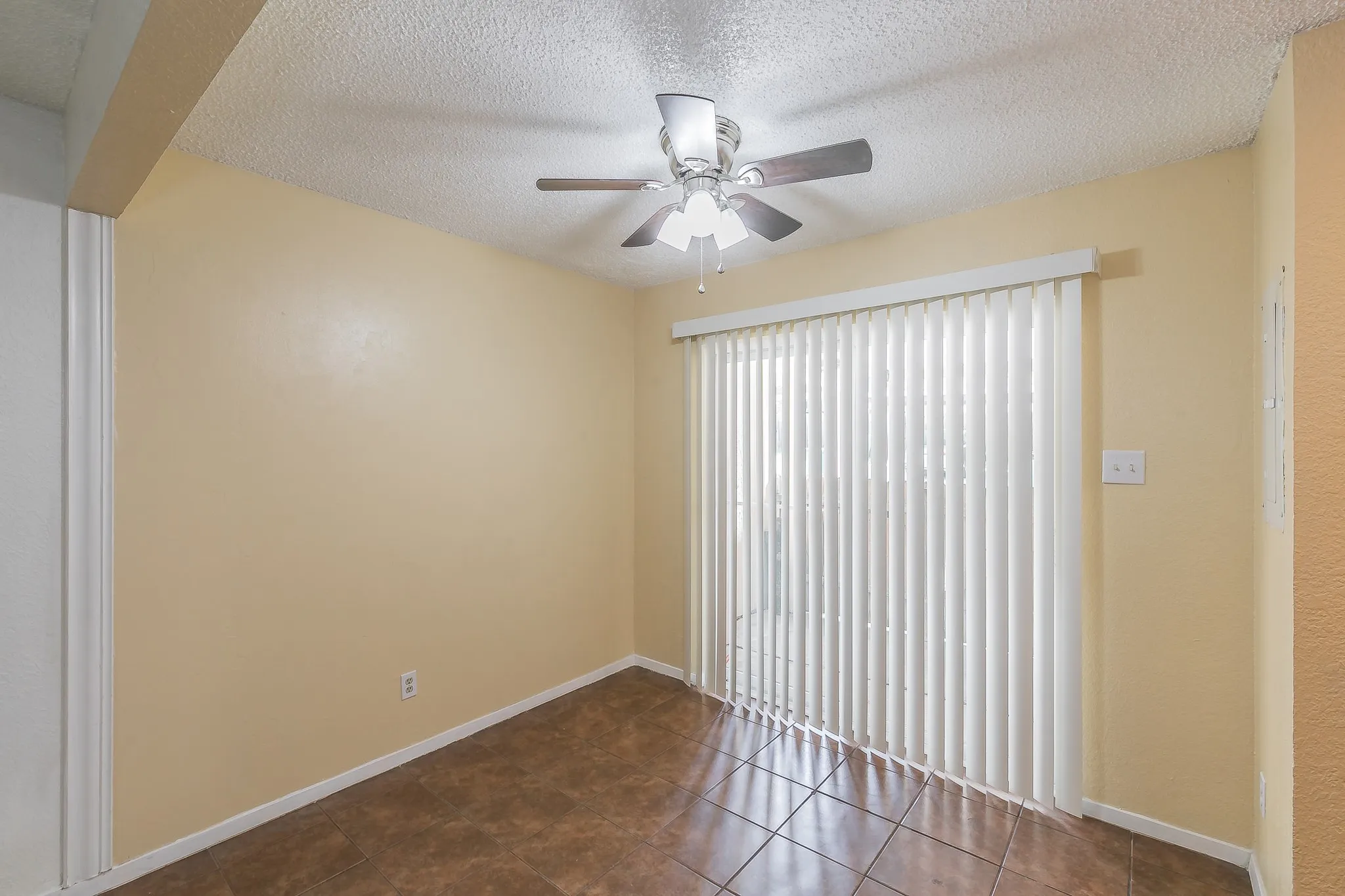 Dinning area with ceiling fan. Could be used as office space.