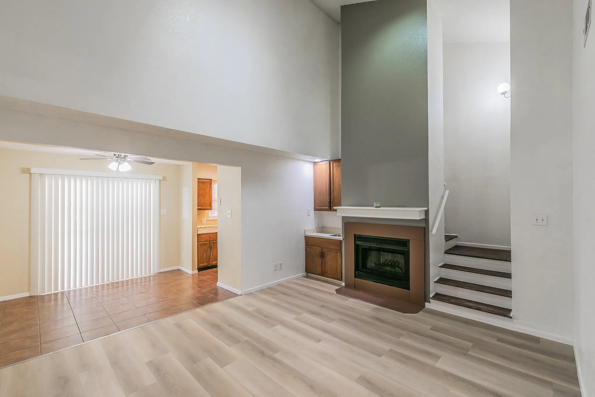 Newly laid  laminate flooring , wood burning fireplace. Stairway leads to Master bedroom