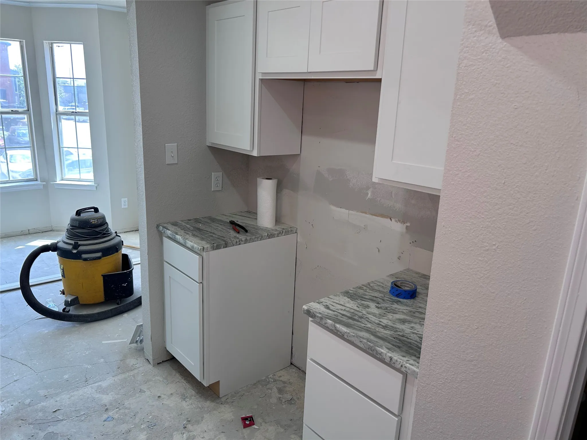 Renovations underway. The kitchen has new Shaker-style cabinets, granite counters, and recessed lighting. New vinyl plank flooring, tile backsplash, sink, 2" blinds, and appliances will be installed soon.