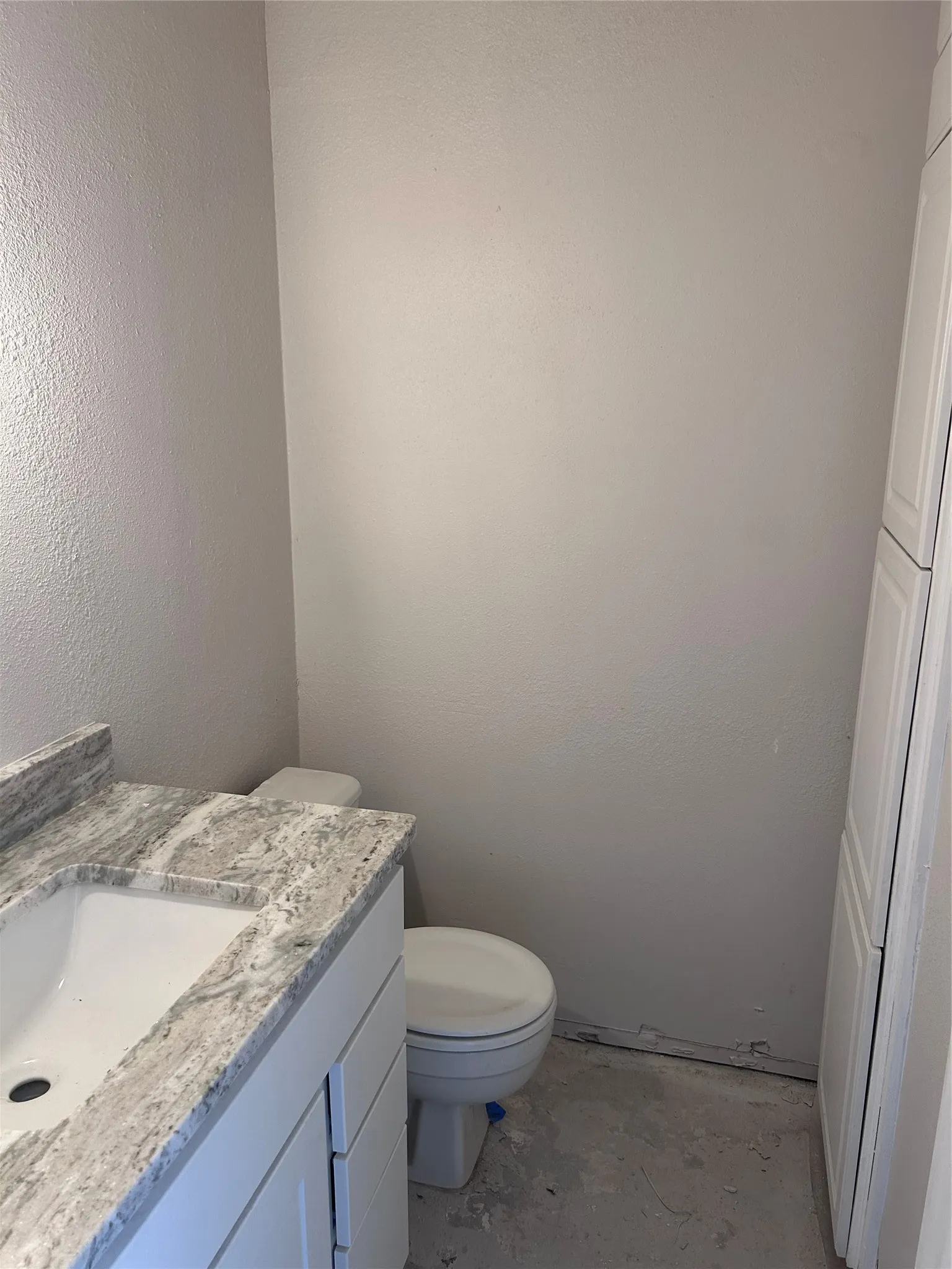 Renovations underway in the main floor half bath. New cabinets, granite counters, and sink. Still to come: toilet, vinyl plank flooring, light fixture, mirror, and hardware.