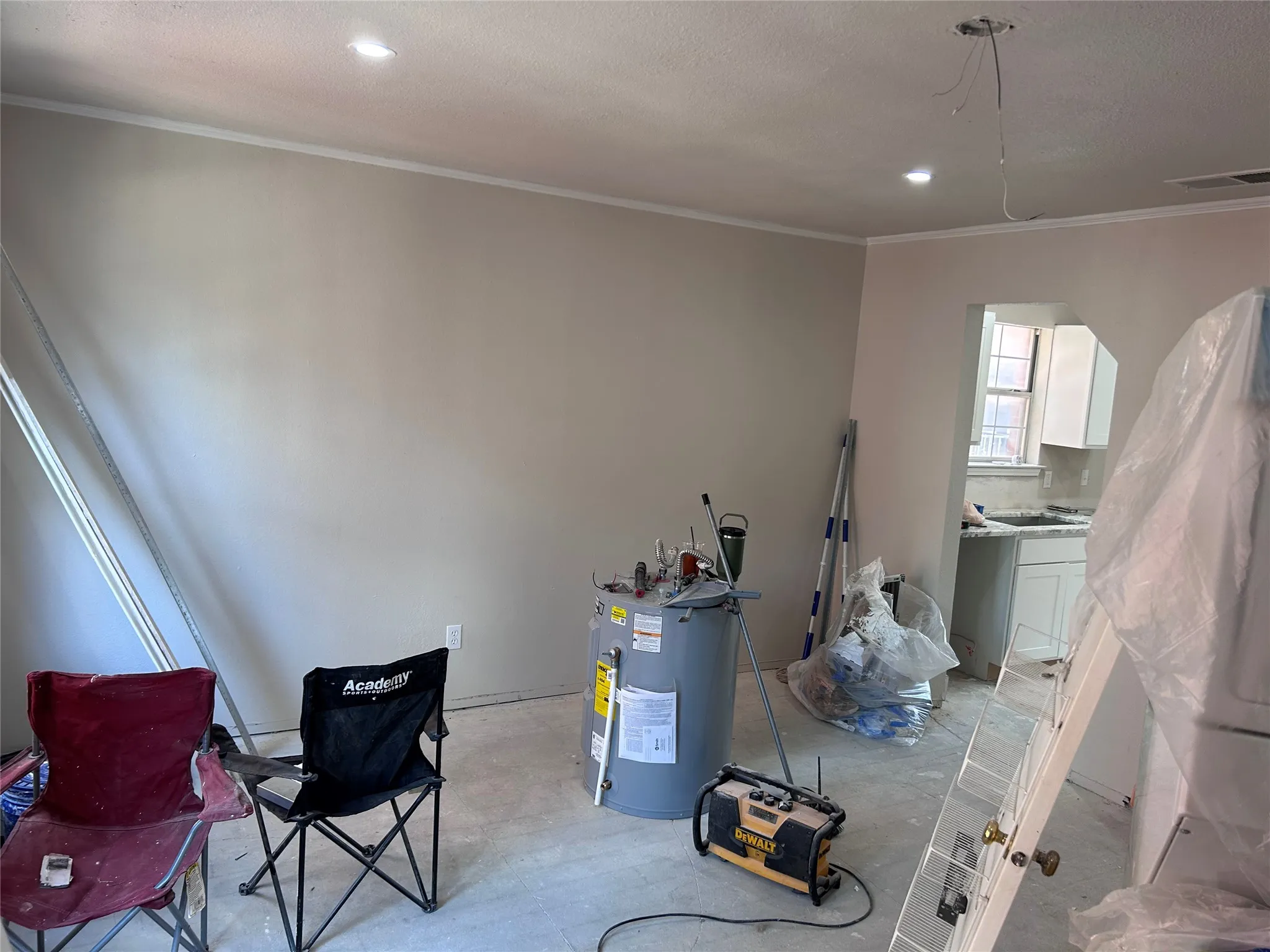 Renovations underway in the family room. New French doors to the balcony and recessed lighting. Vinyl plank flooring and a ceiling fan will be installed soon.