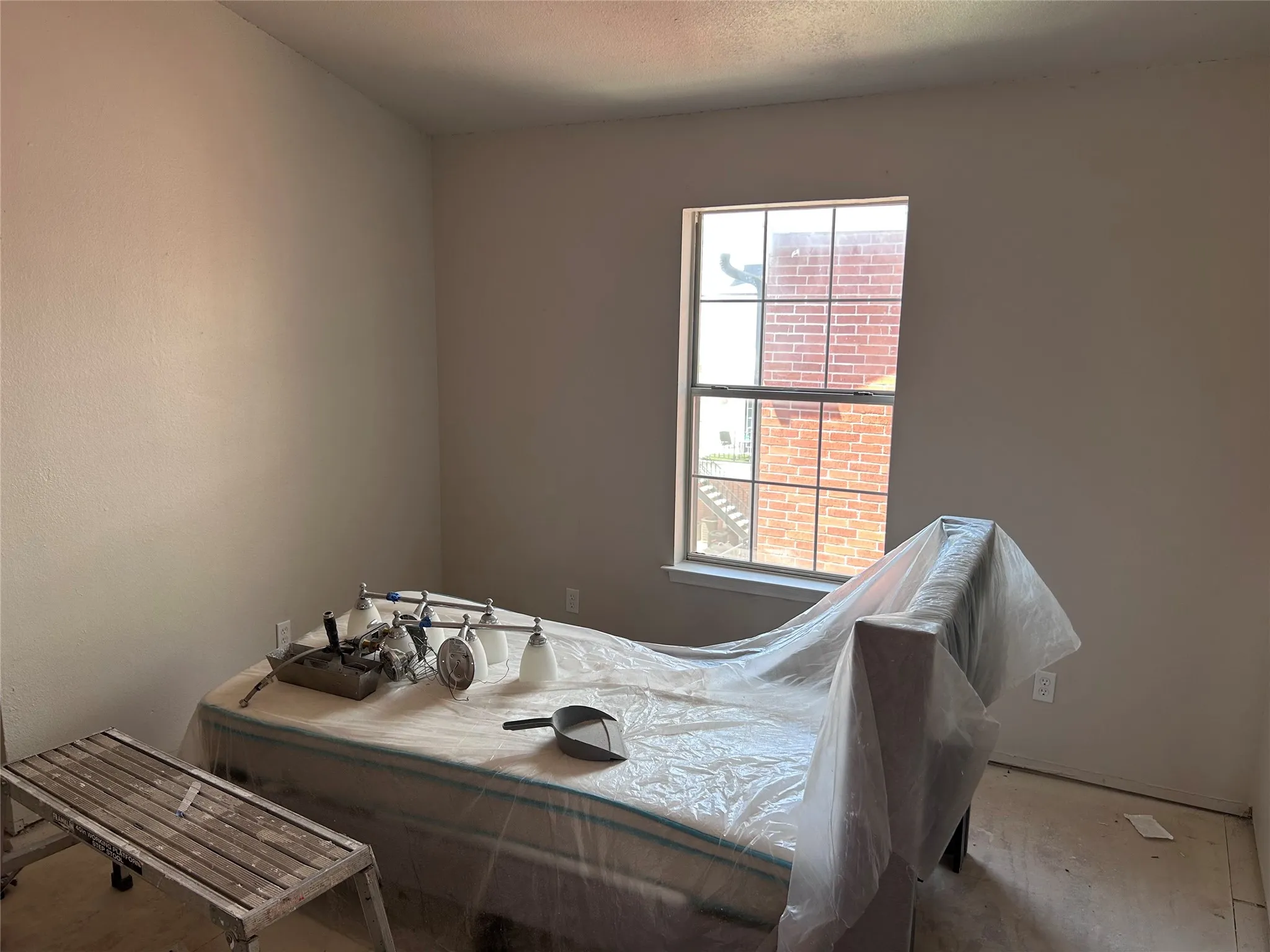 Renovations underway in one of two almost identical bedrooms. New vinyl plank flooring, ceiling fan with light, and 2" blinds are yet to come. There's multiple closets with plenty of space.