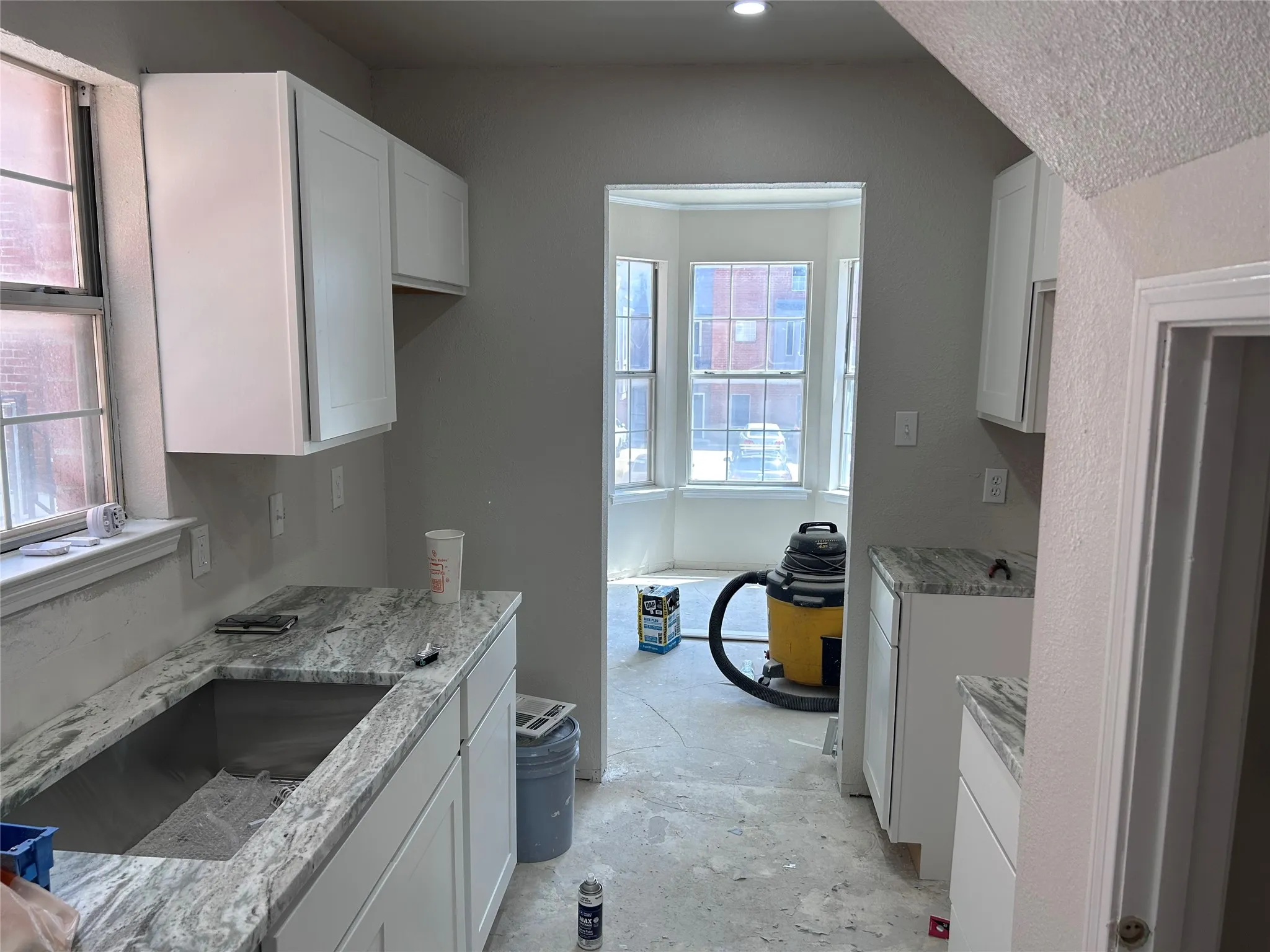 Renovations underway. The kitchen has new Shaker-style cabinets, granite counters, and recessed lighting. New vinyl plank flooring, tile backsplash, sink, 2" blinds, and appliances will be installed soon.
