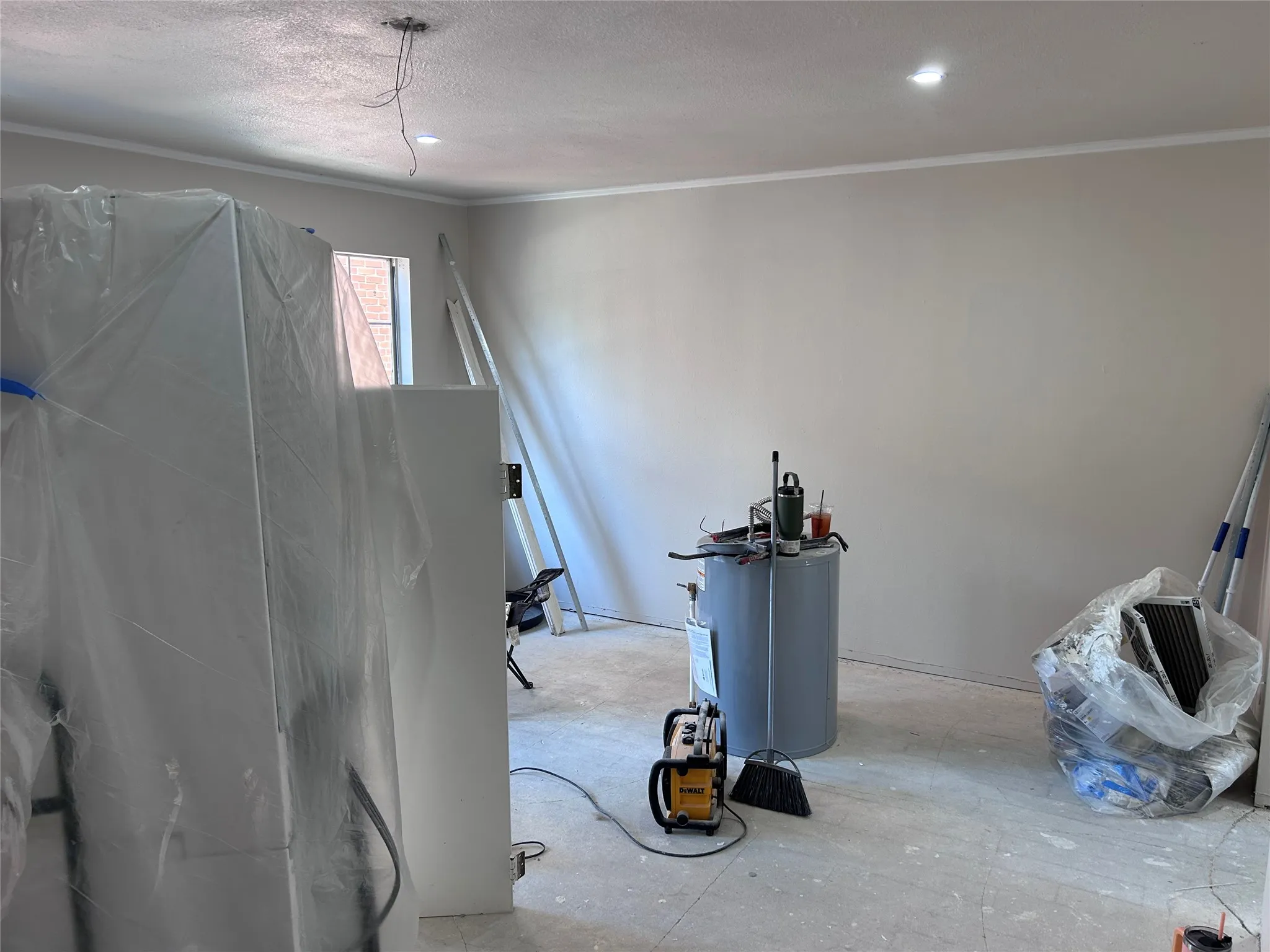 Renovations underway in the family room. New French doors to the balcony and recessed lighting. Vinyl plank flooring and a ceiling fan will be installed soon.