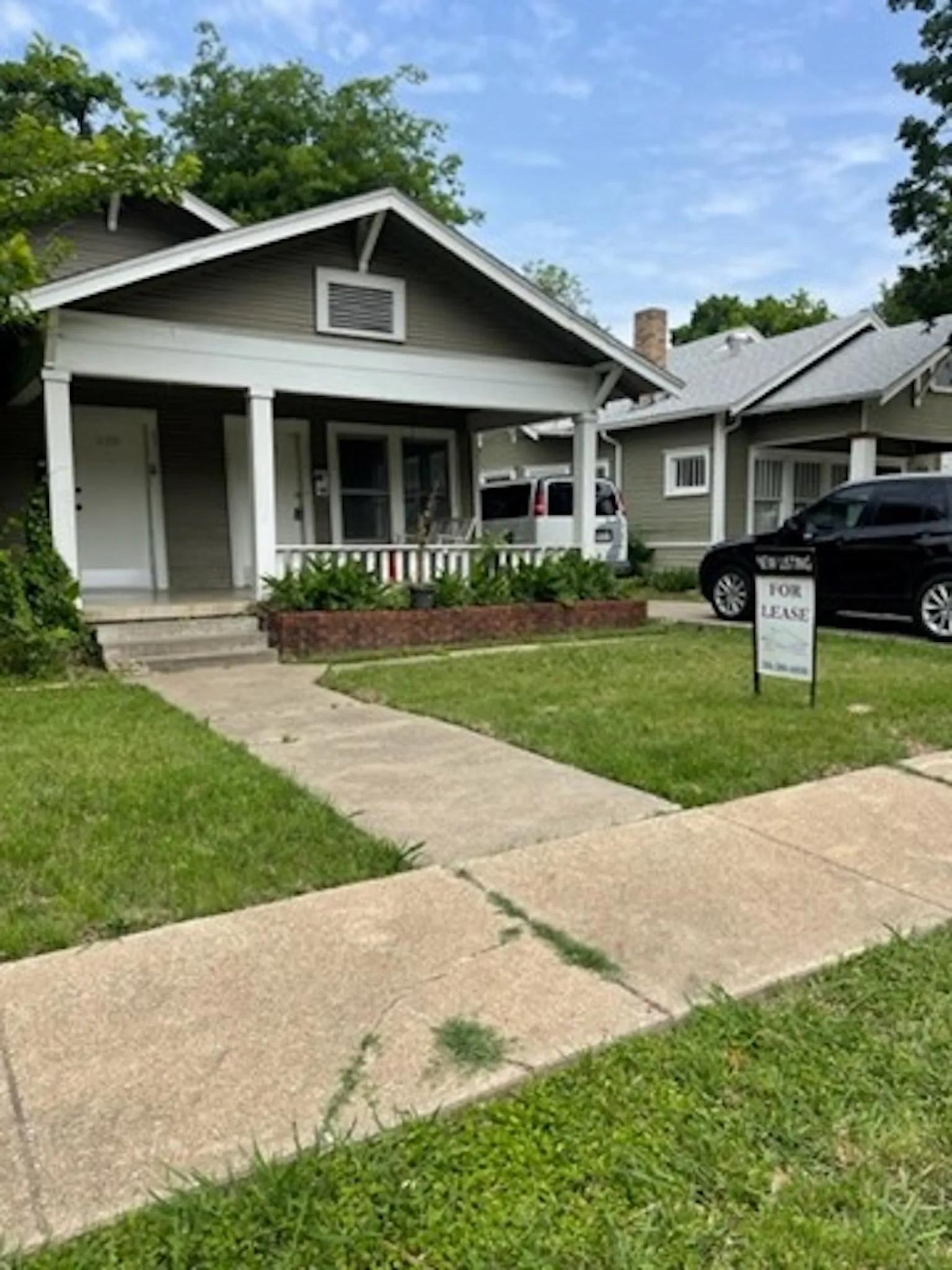 Bungalow featuring a chimney, a porch, and a front yard