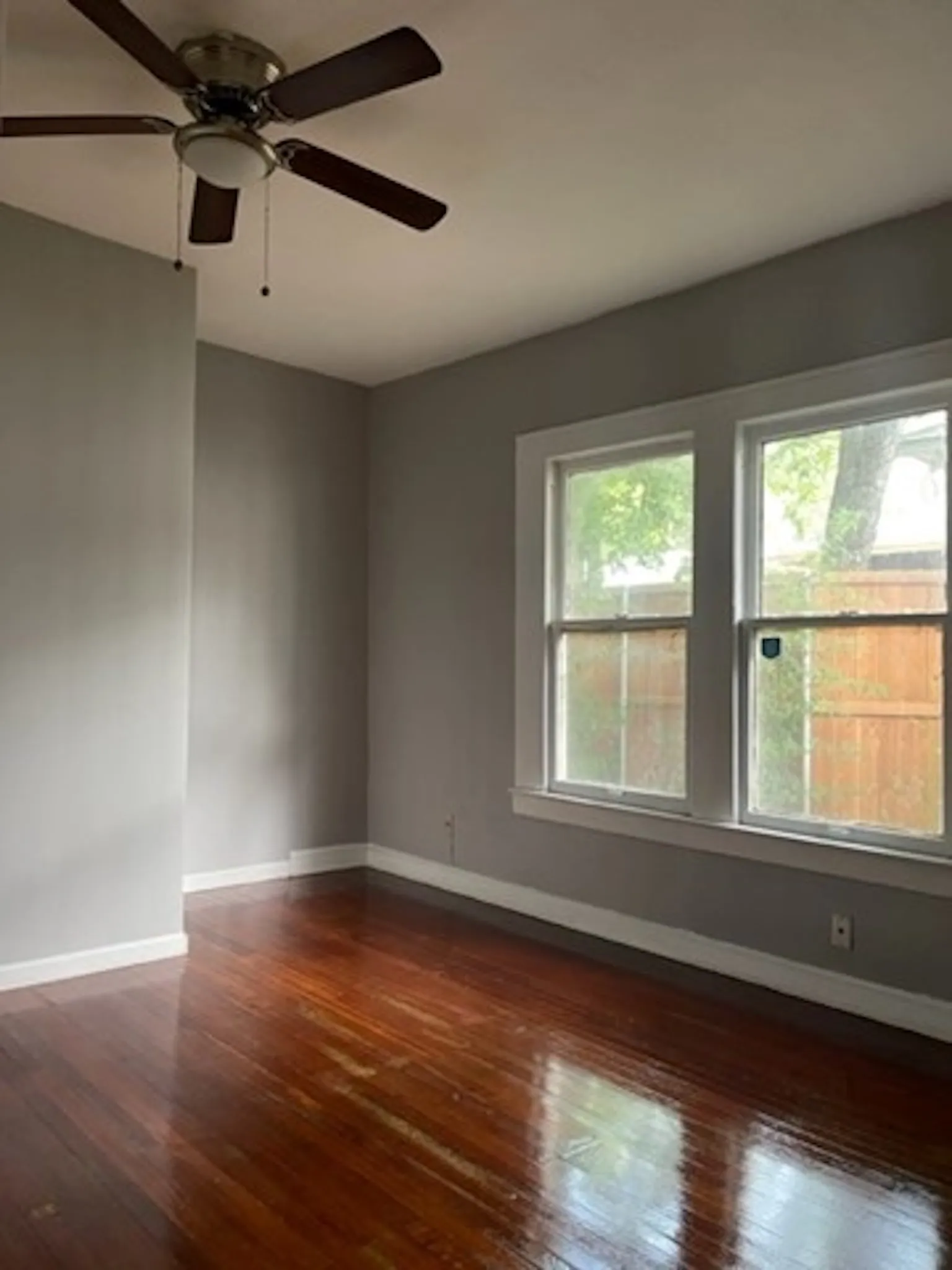 Unfurnished room with dark wood finished floors and baseboards