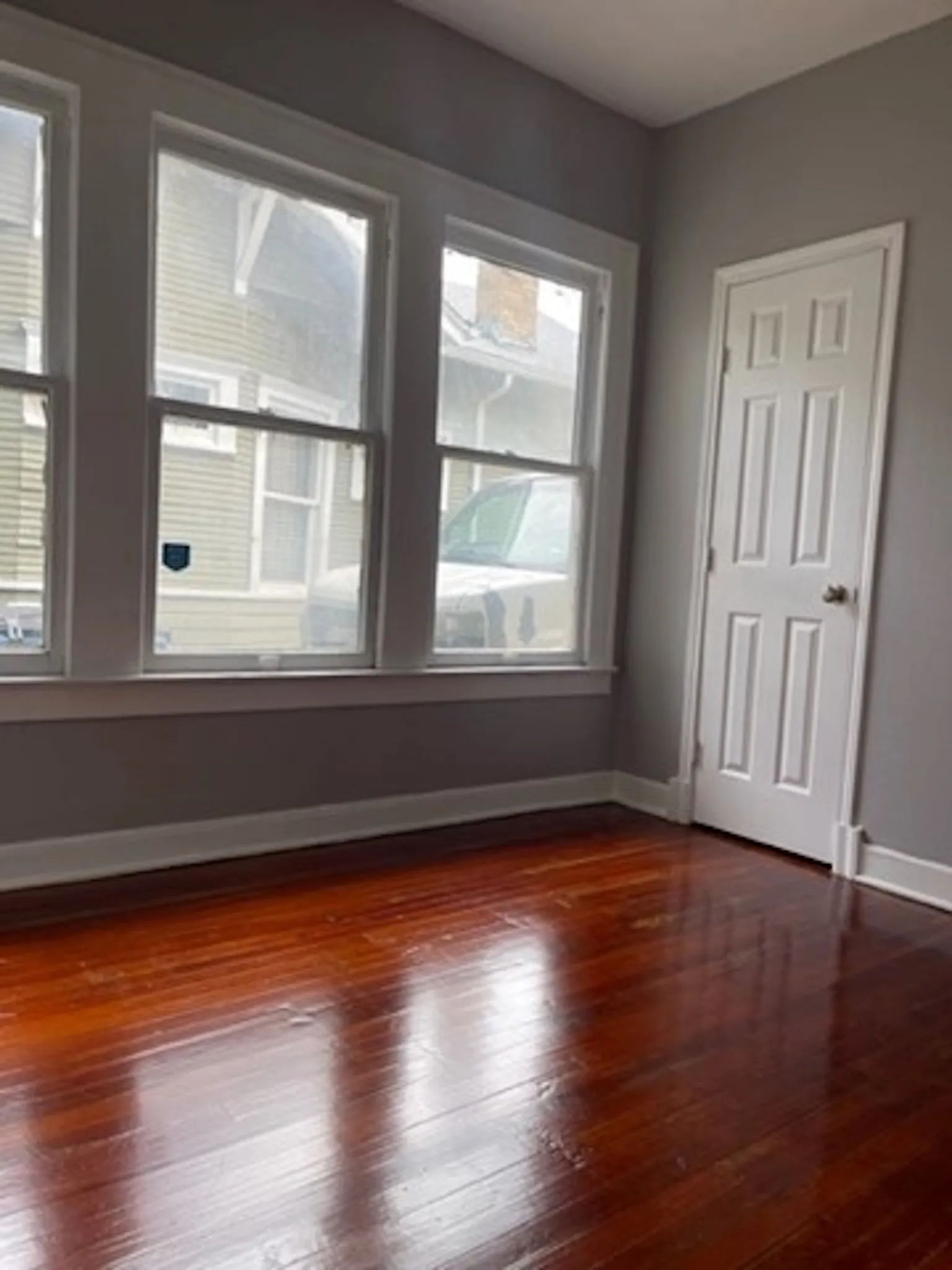 Unfurnished room featuring baseboards and wood finished floors