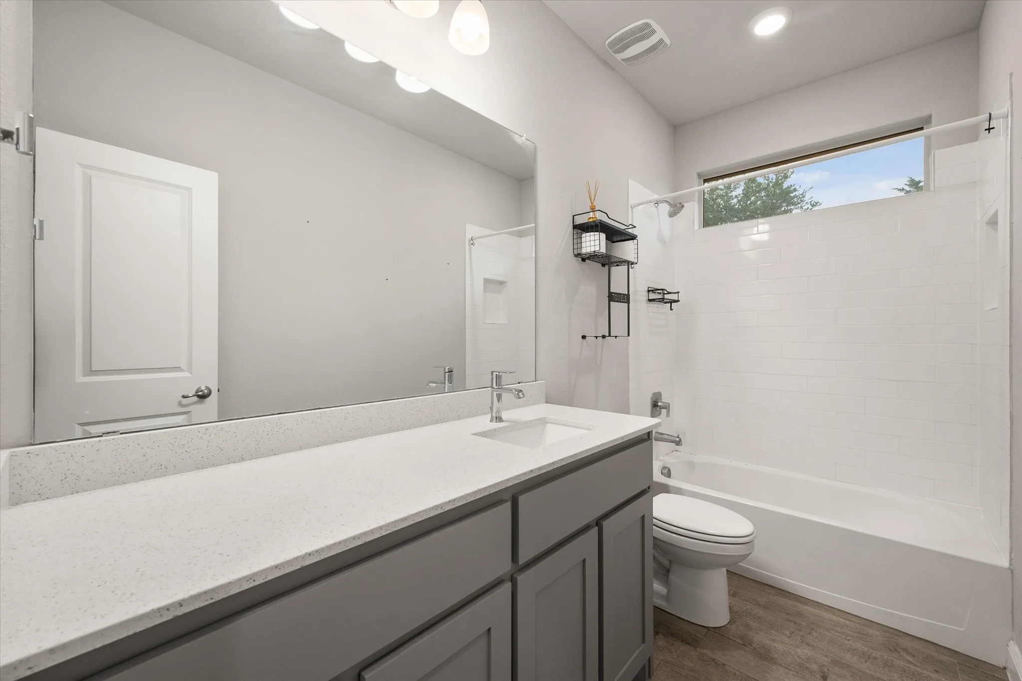 Contemporary bathroom featuring gray shaker cabinetry