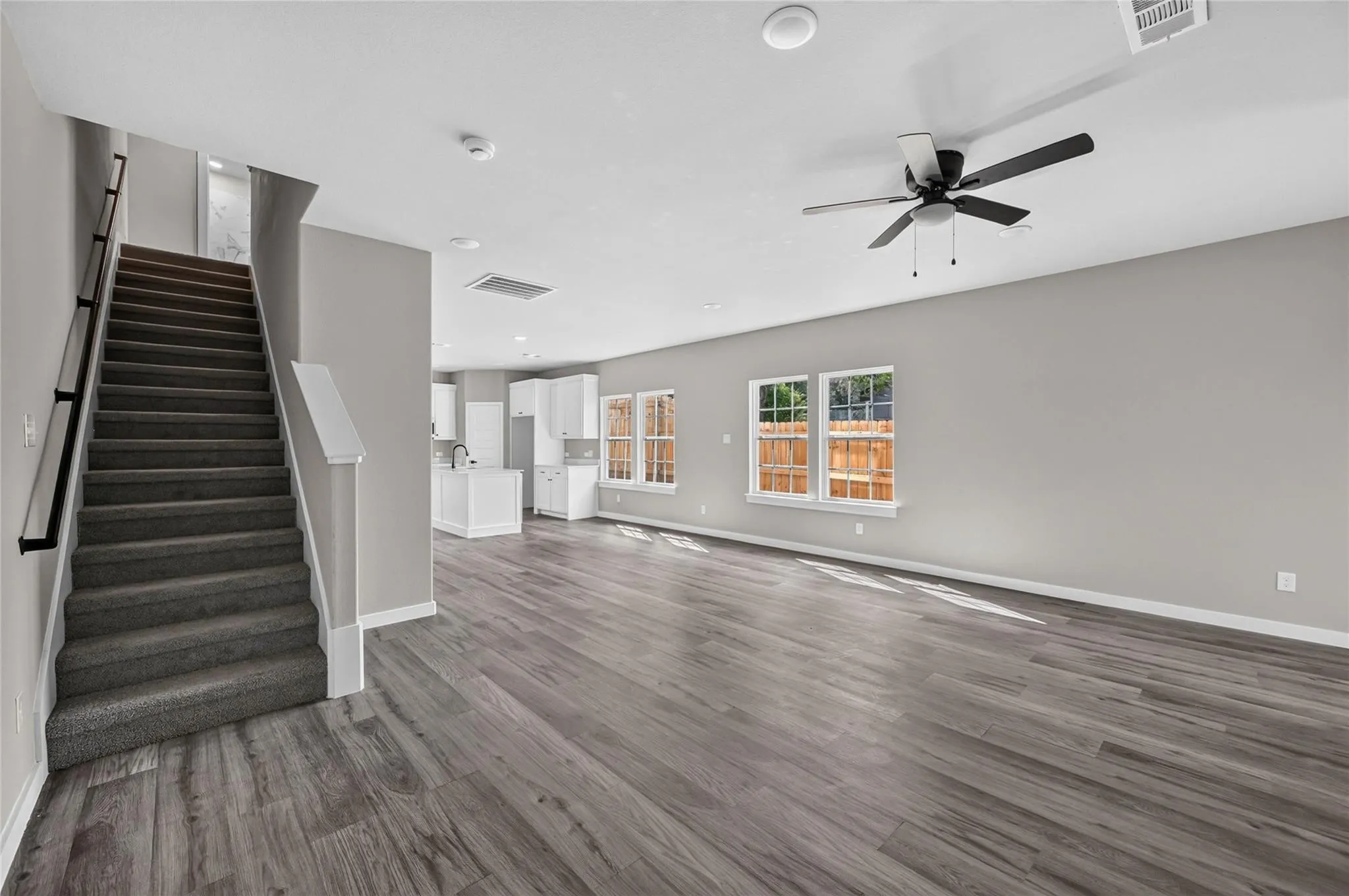 Open concept floor plan featuring wood-finish flooring, recessed lighting, and a ceiling fan