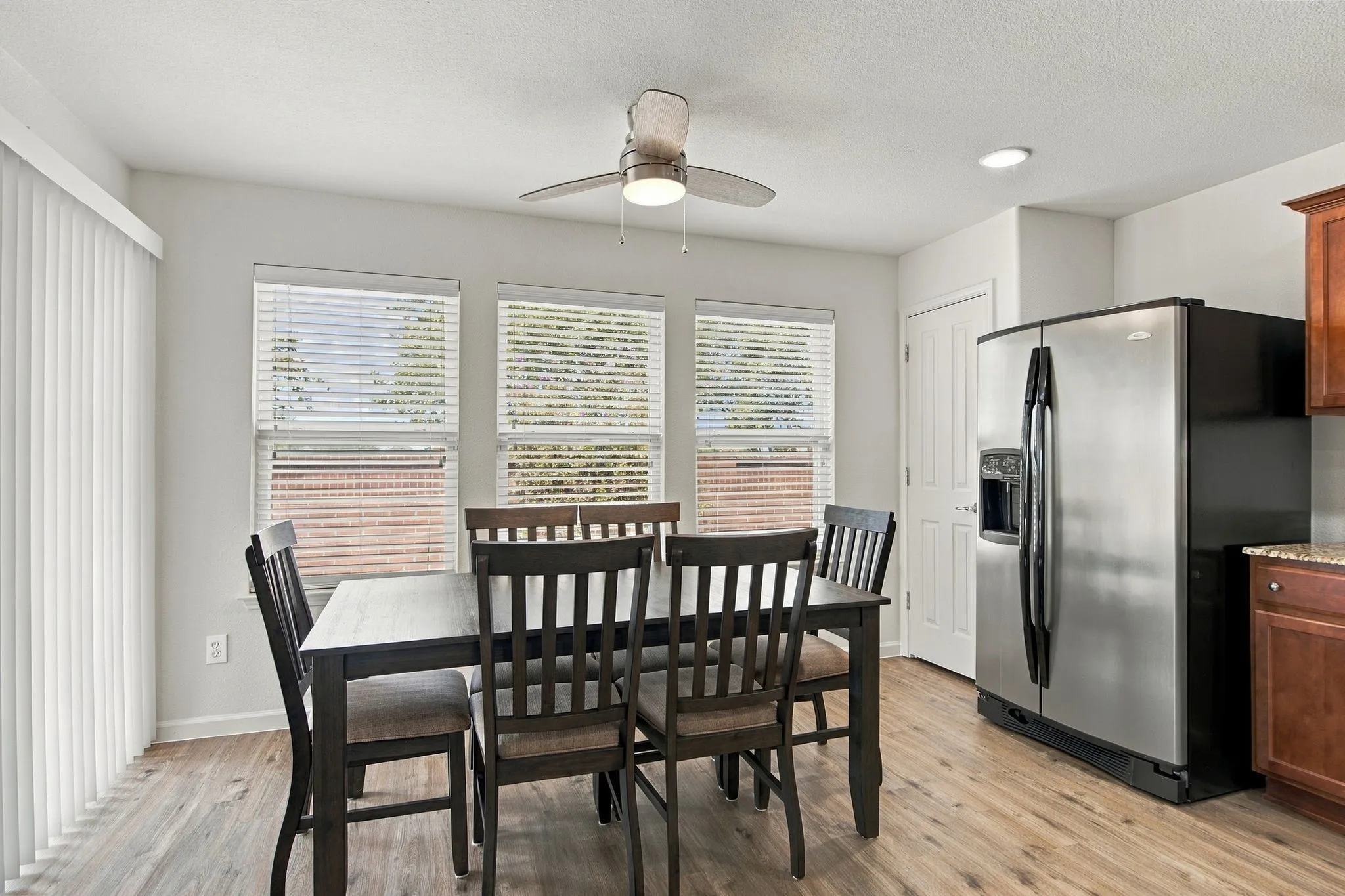 Abundant Natural Light Bathes The Dining Area That's A Great Place For Morning Coffee As Well As Playing Cards And Games With Friends.  Exit The Sliding Glass Doors To The Covered Patio.