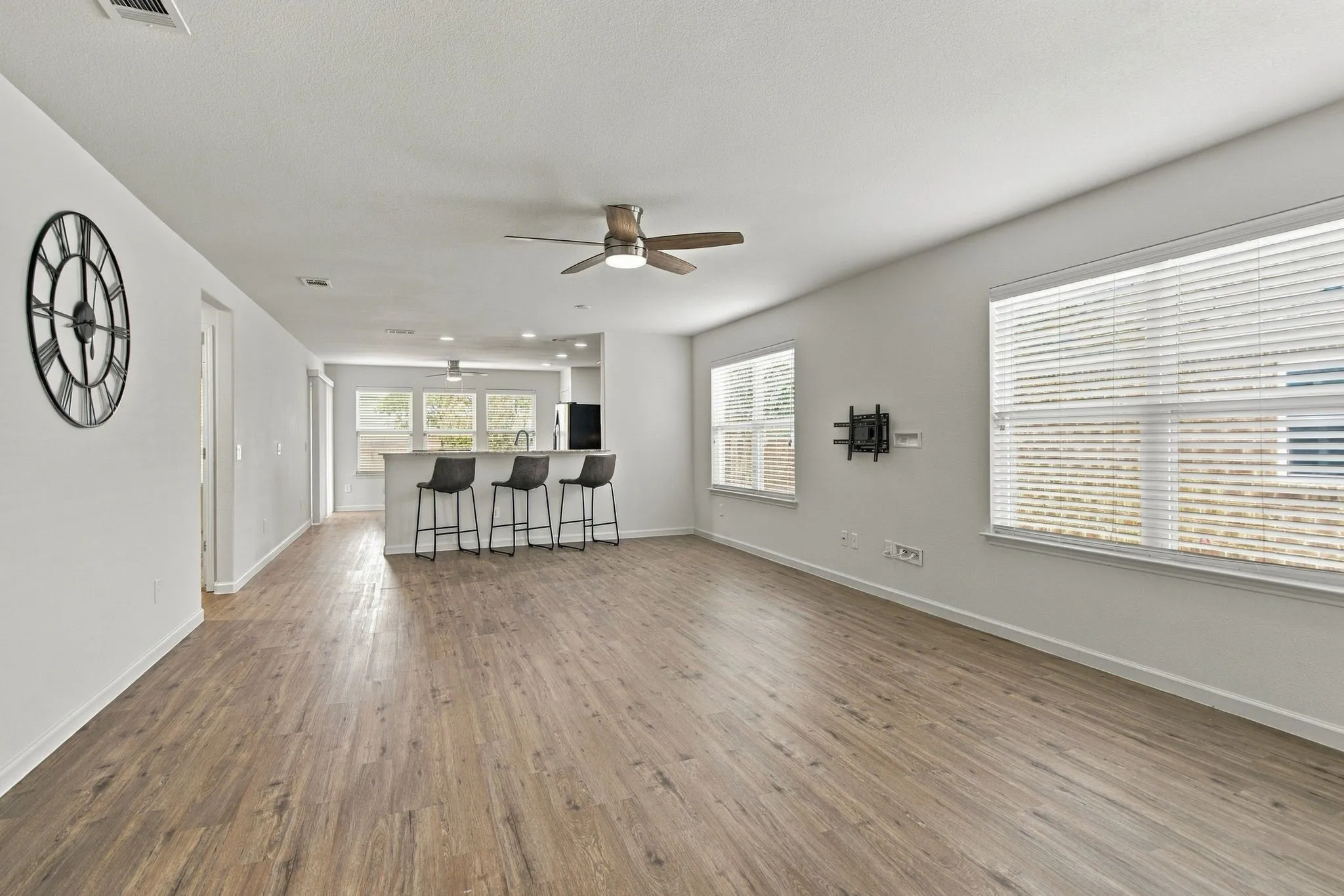 Recently Modernized Vinyl Plank Flooring And Designer Ceiling Fan Accent The Living Room Where Abundant Natural Light Provides Such An Open, Airy Feel.