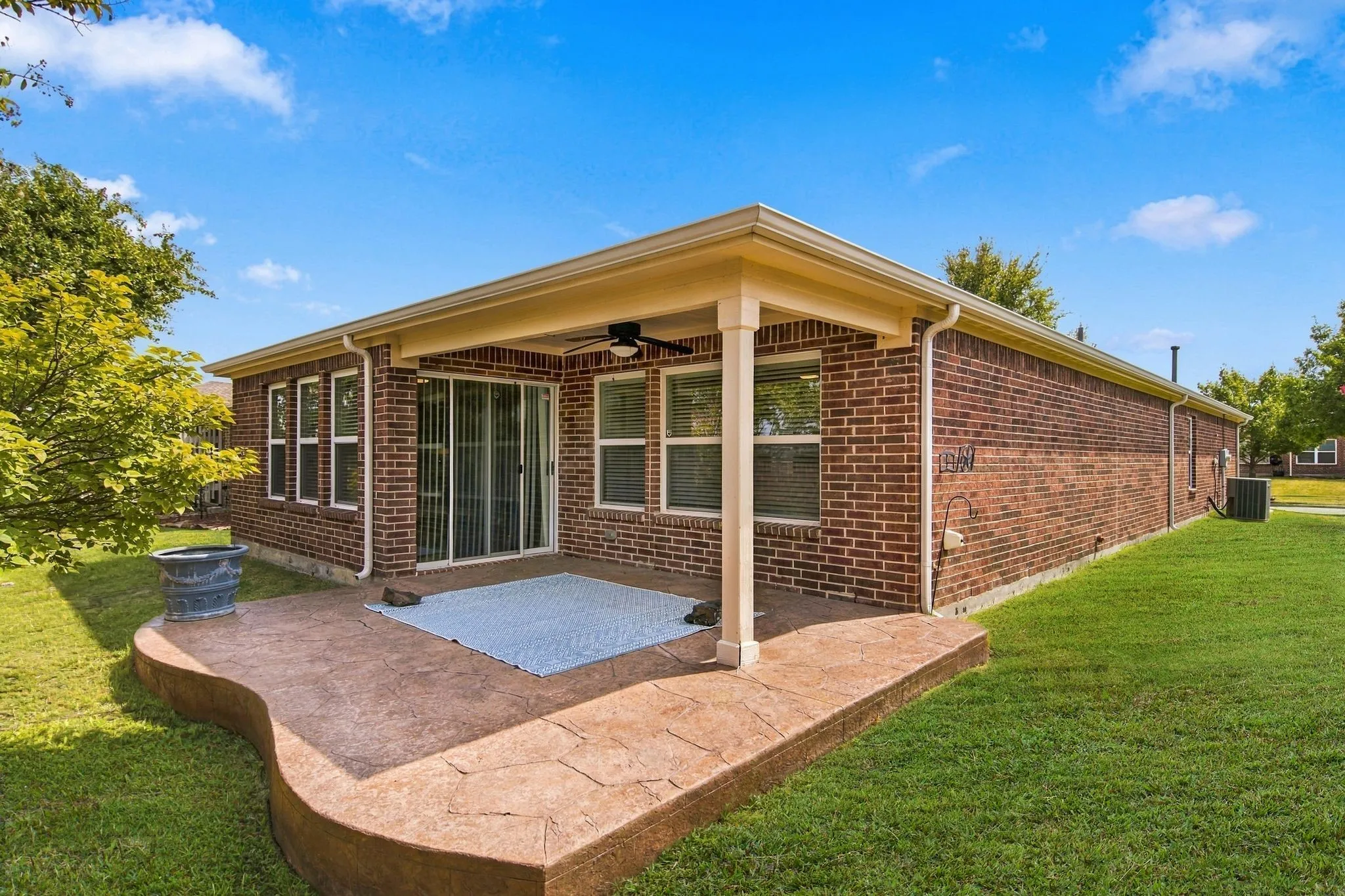 You'll Enjoy Relaxing With Neighbors On The Open And Covered Patio Areas Where A Custom Floor Finish Offers The Appearance Of Flagstone.