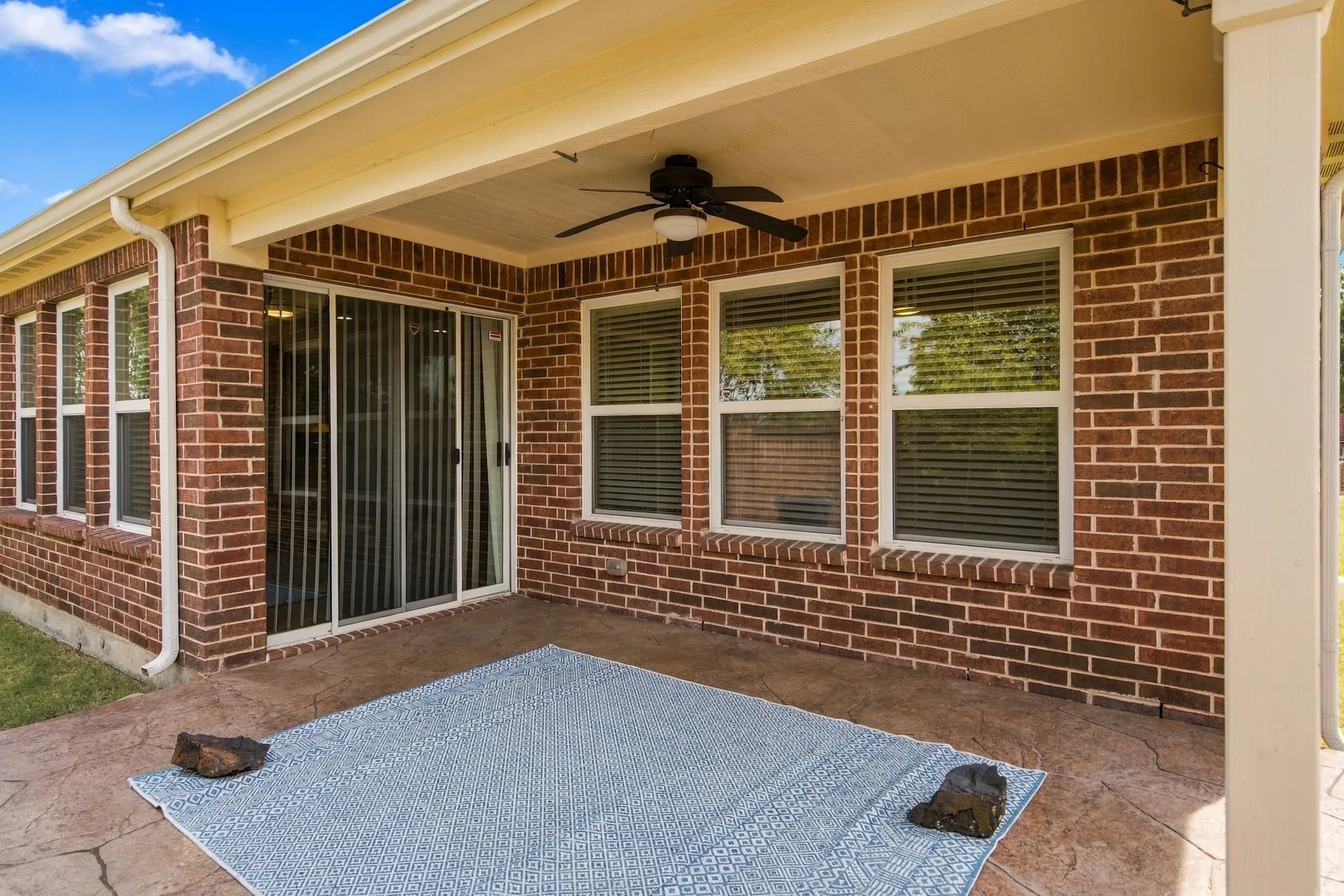 A Ceiling Fan Keeps You Cool At The Covered Patio.