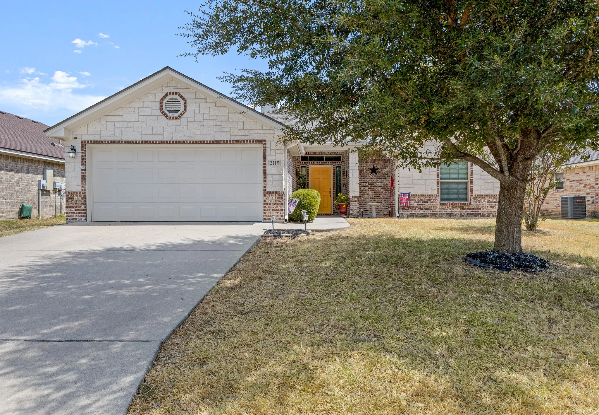 Stone and brick exterior with a two-car garage