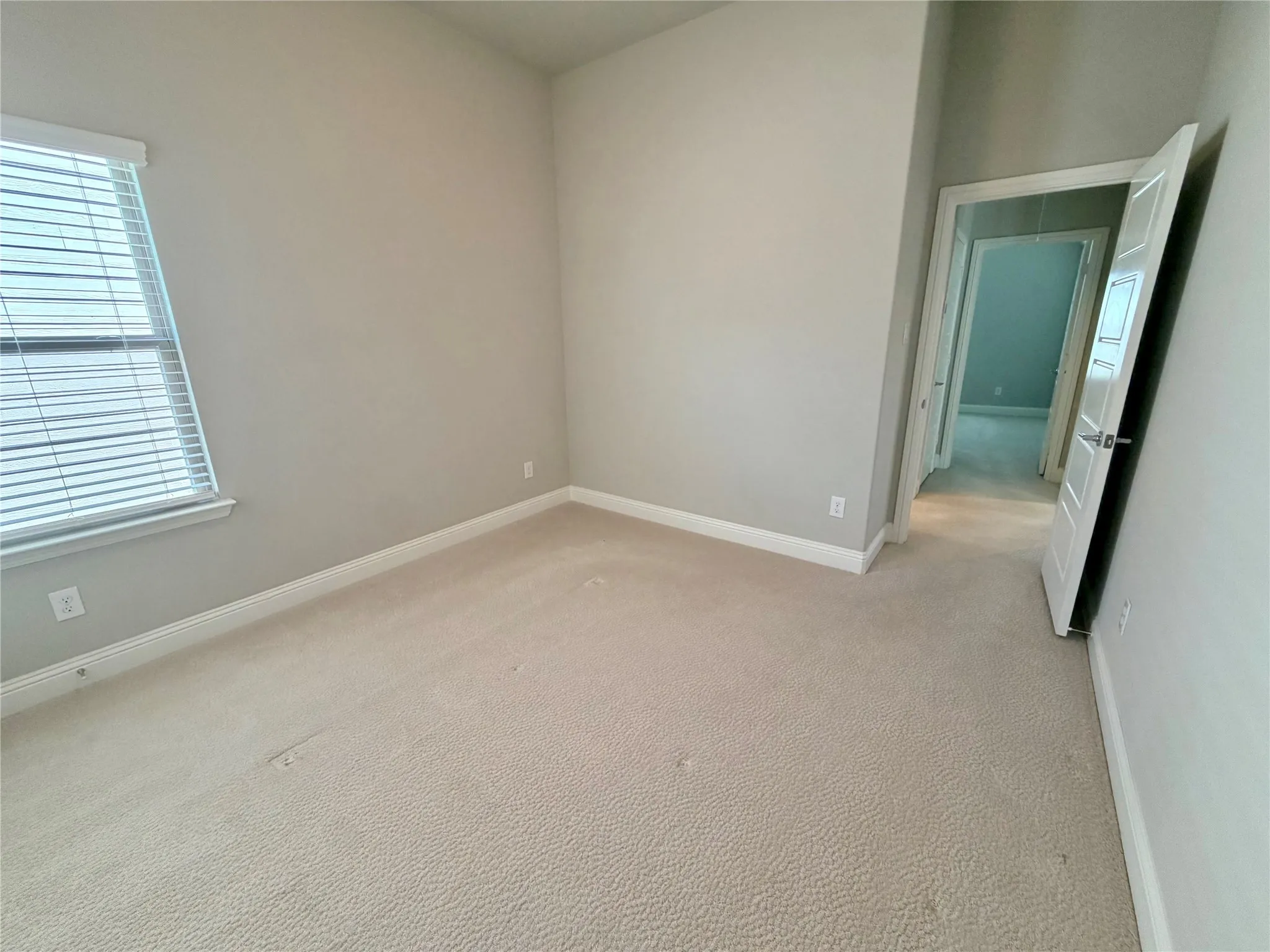 Neutral-toned walls complement plush carpeting
