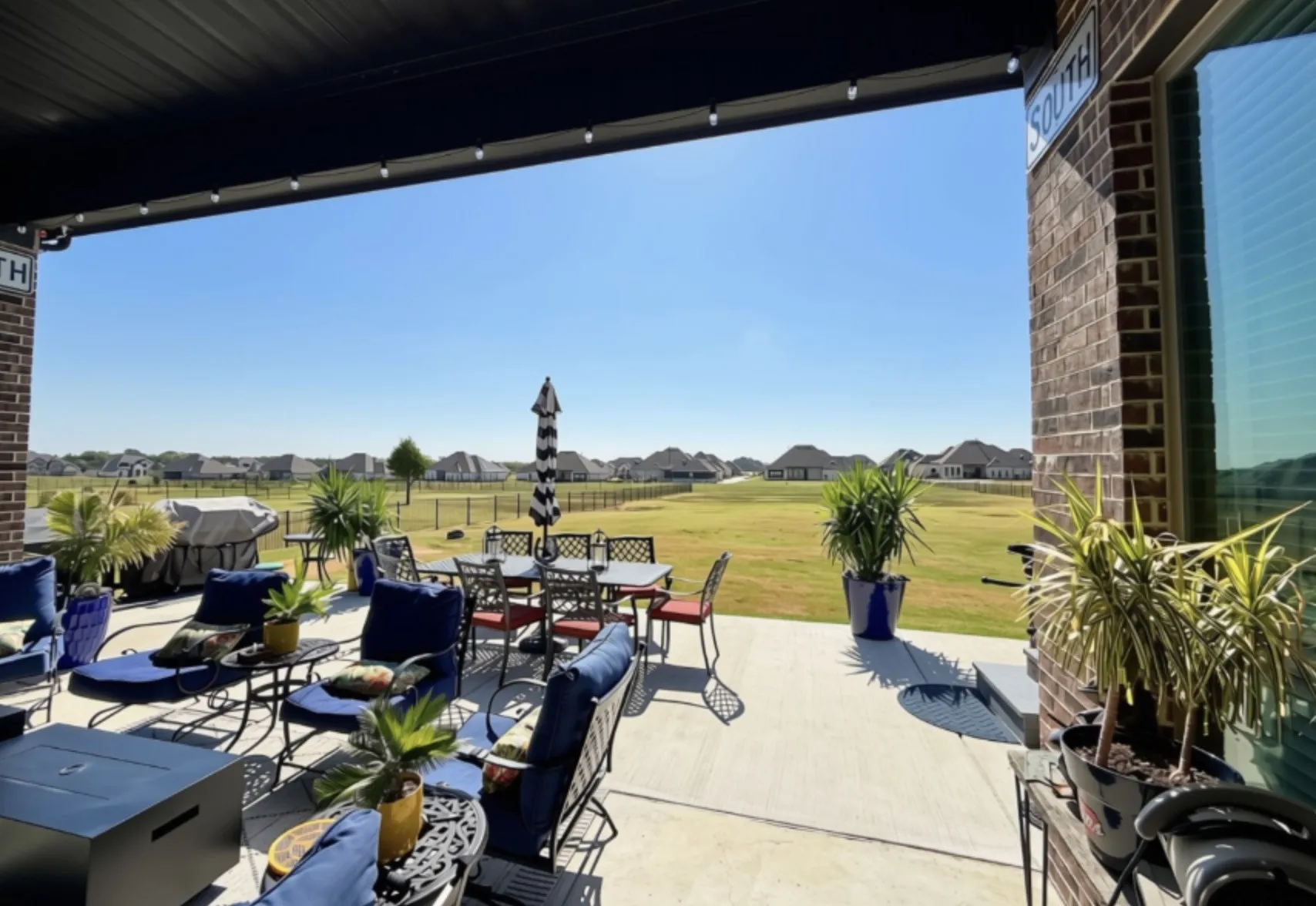 Covered patio with brick exterior and concrete flooring