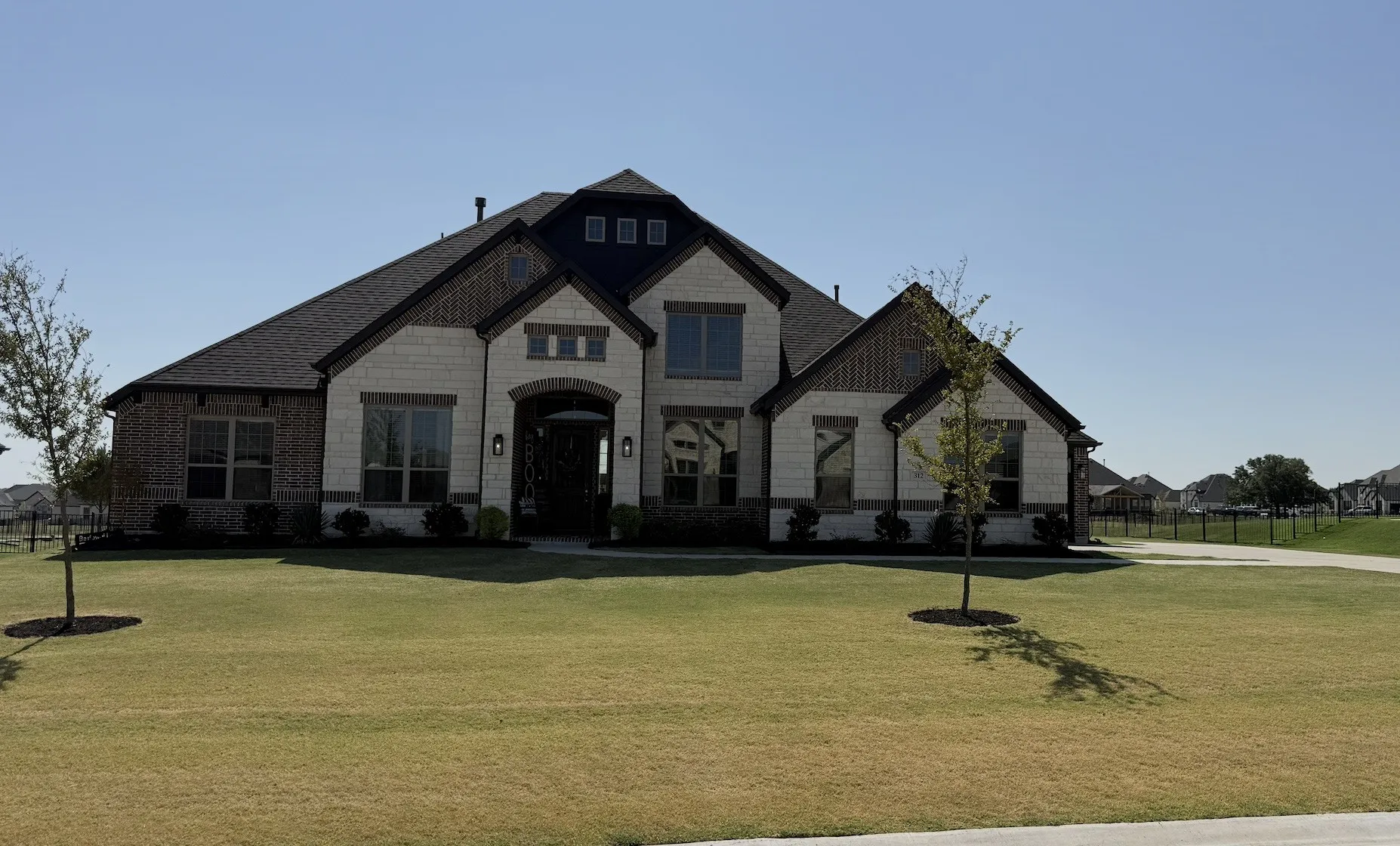 Brick and stone veneer exterior with dark trim accents