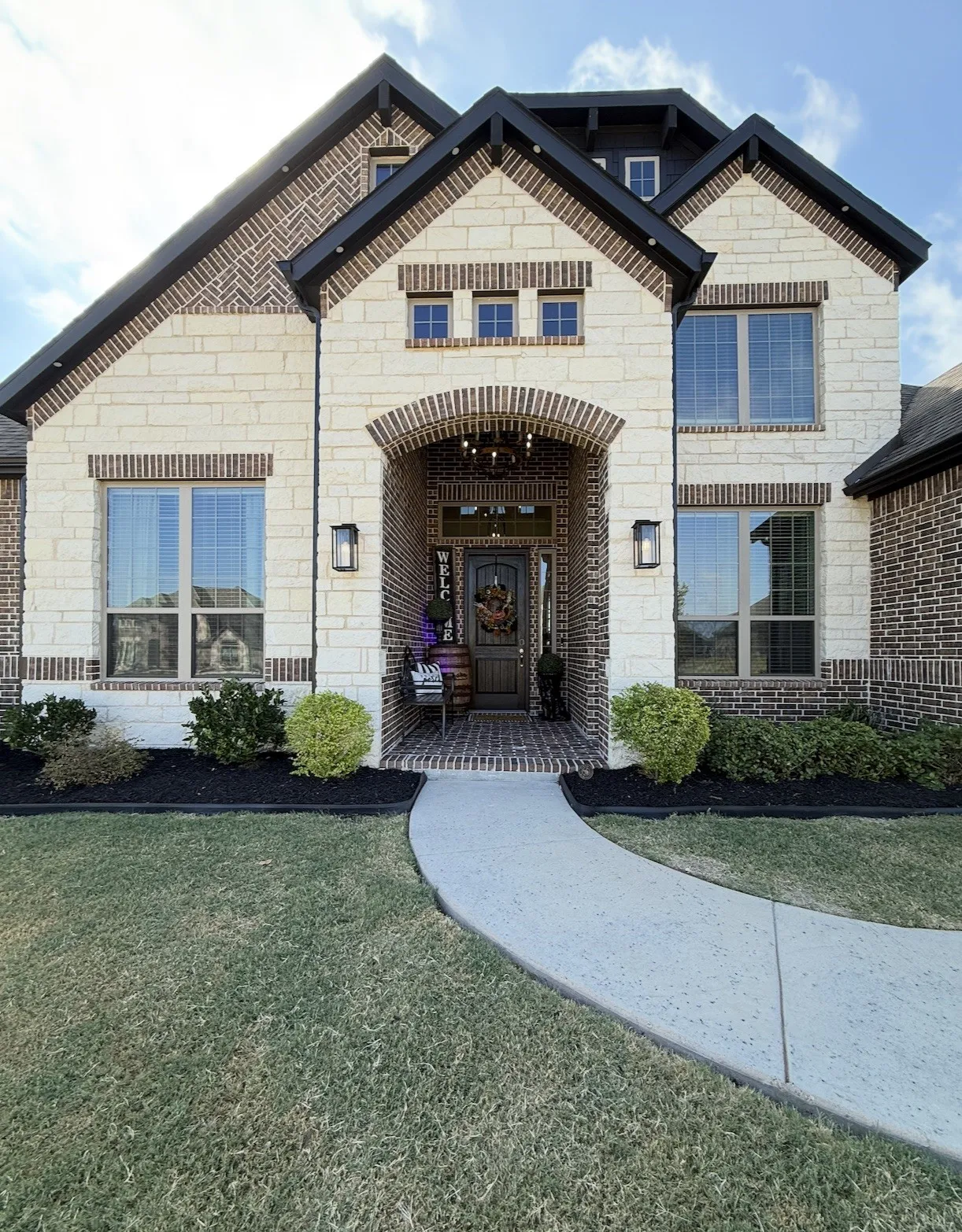 Stone and brick exterior with dark trim accents