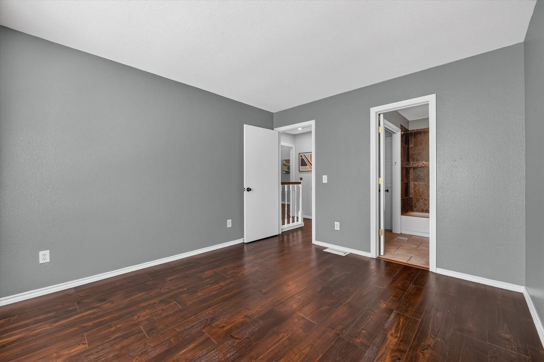 Wood-finish flooring with a satin sheen and light gray wall paint