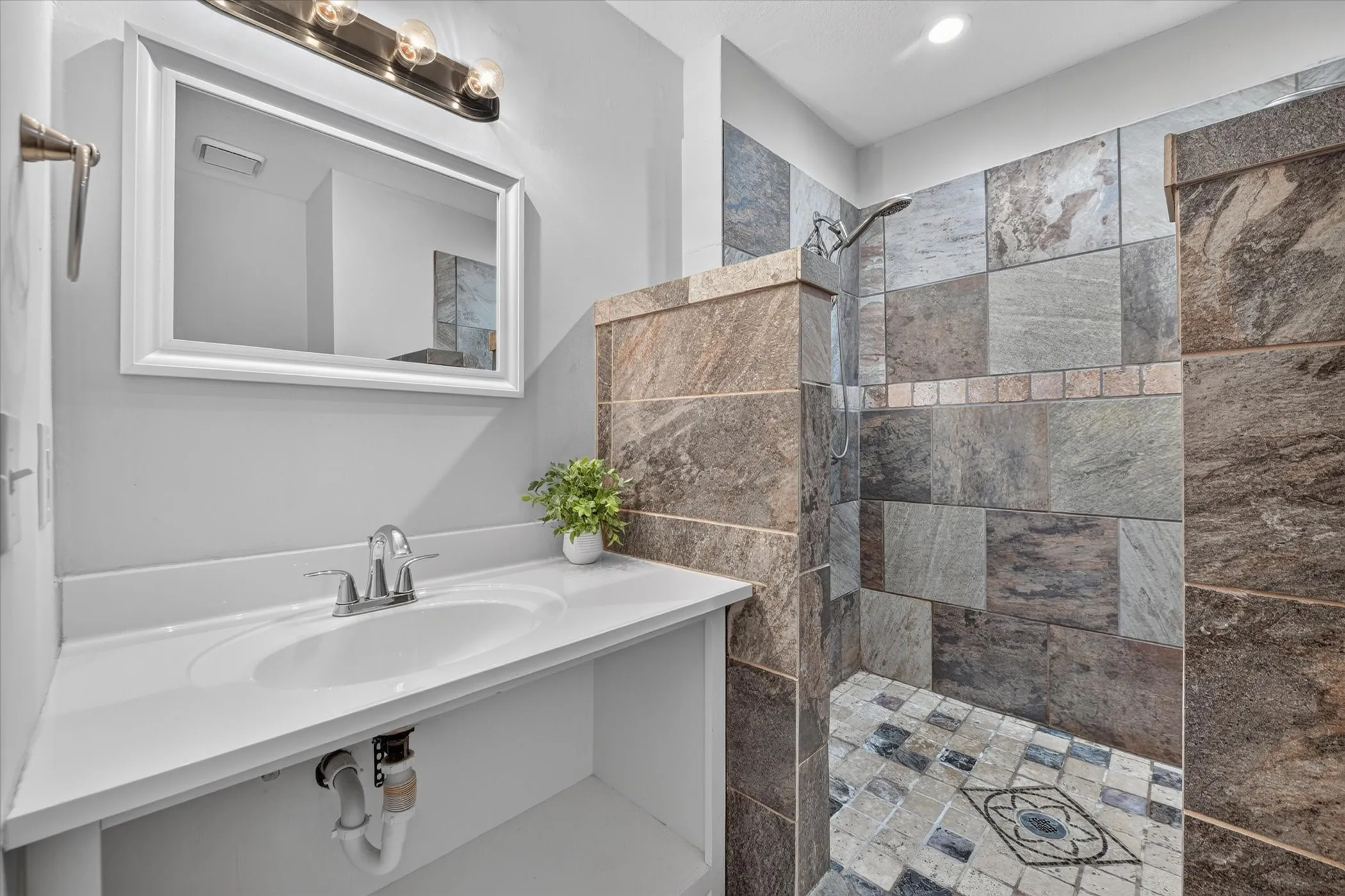 Primary bathroom has large walk-in shower.