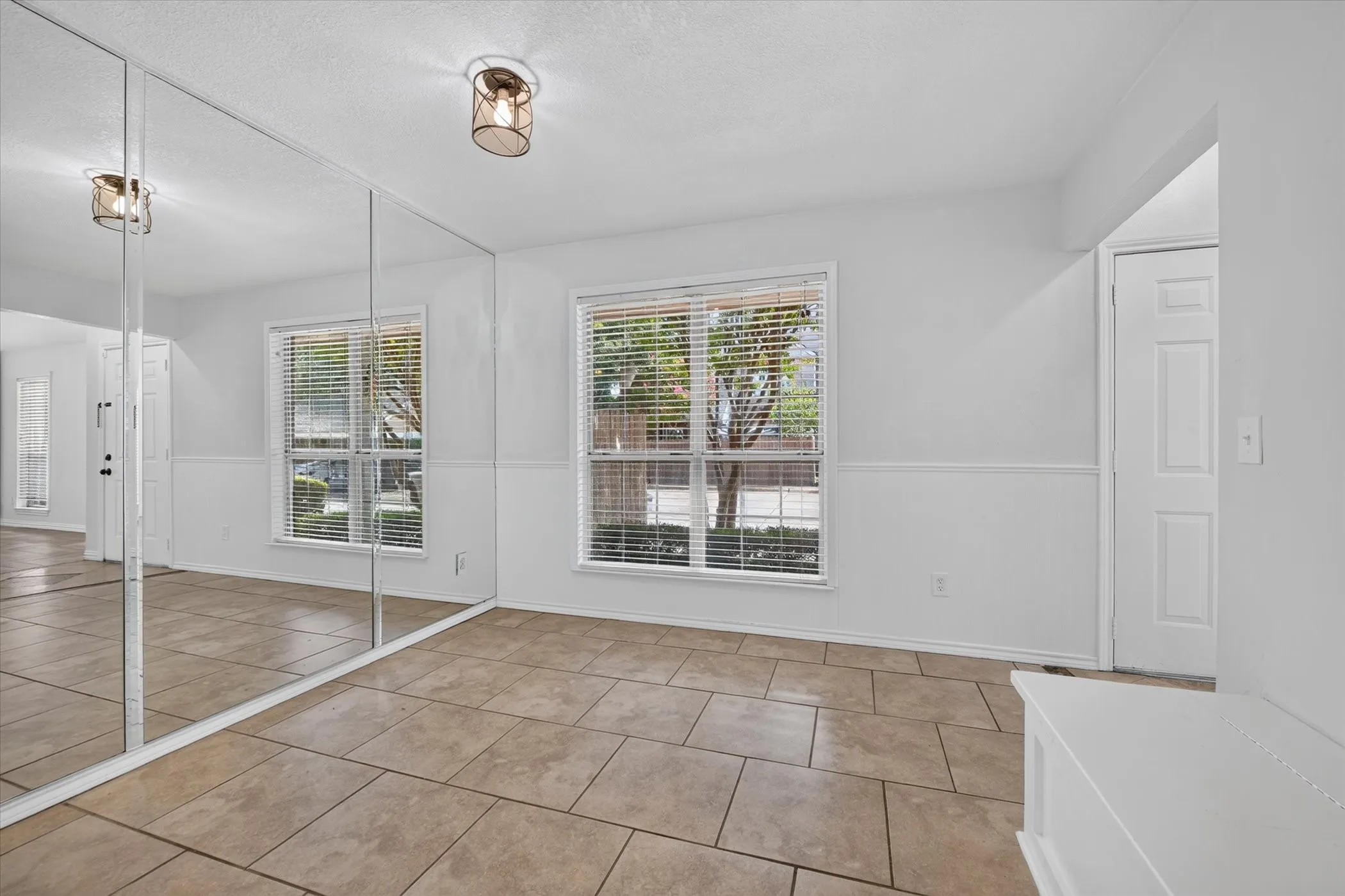Breakfast room off of kitchen has large window for natural light and bench seat that can also be used for storage.