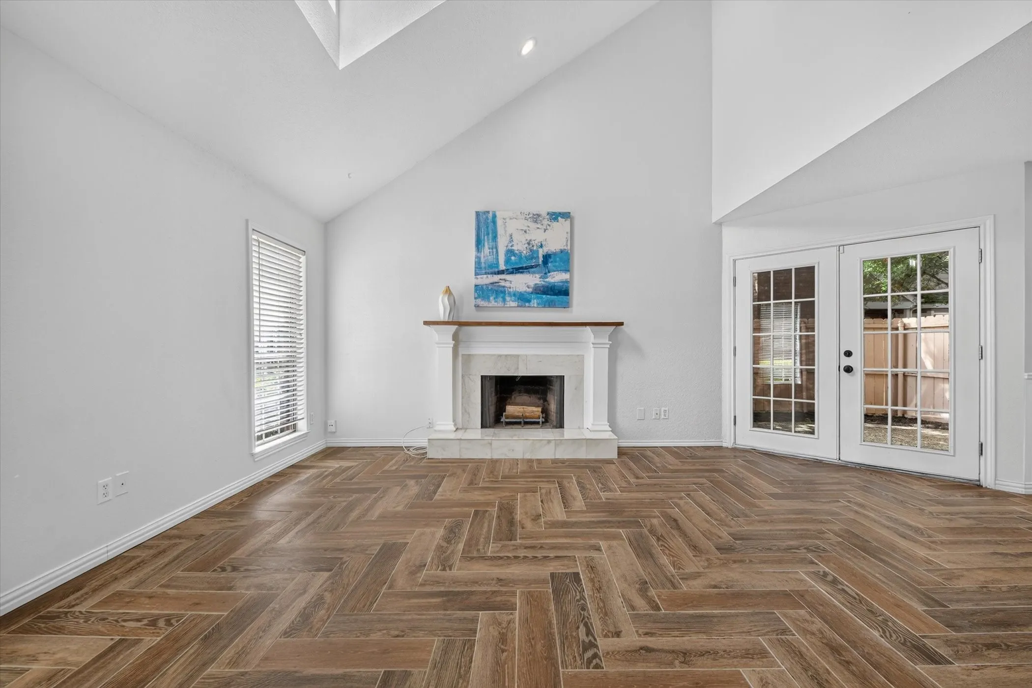 Living room from entry. Vaulted ceiling with nice skylight gives very light & open feel to this space.