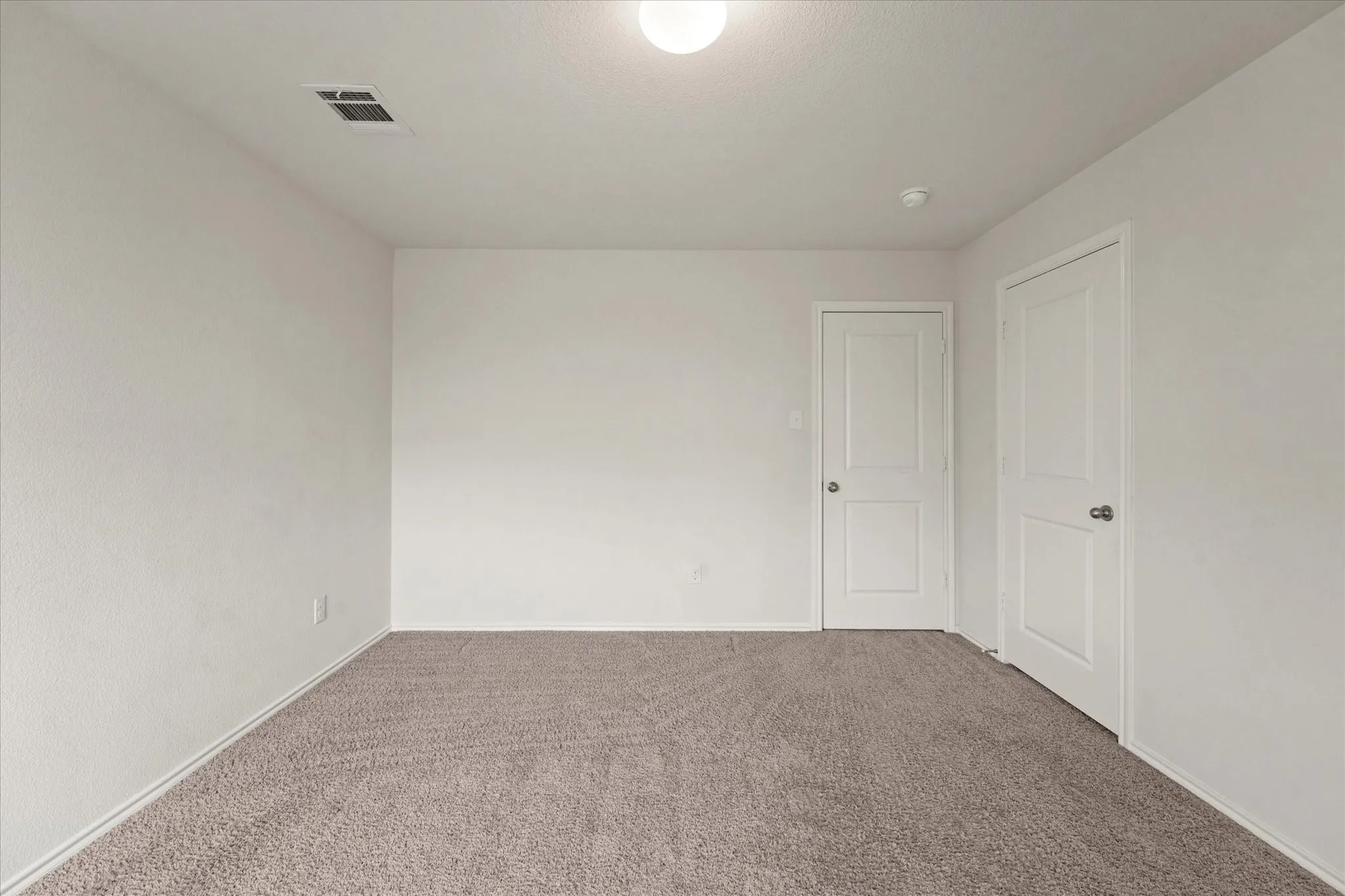 Neutral wall finishes, recessed lighting, and soft carpet flooring