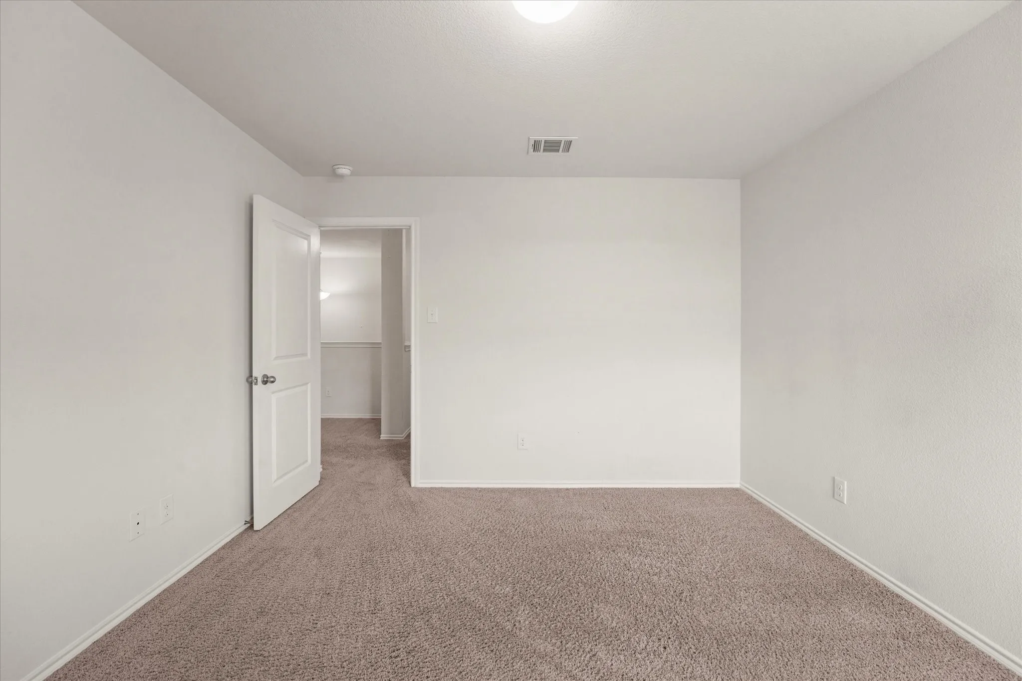 Neutral-toned carpeting and light-colored walls