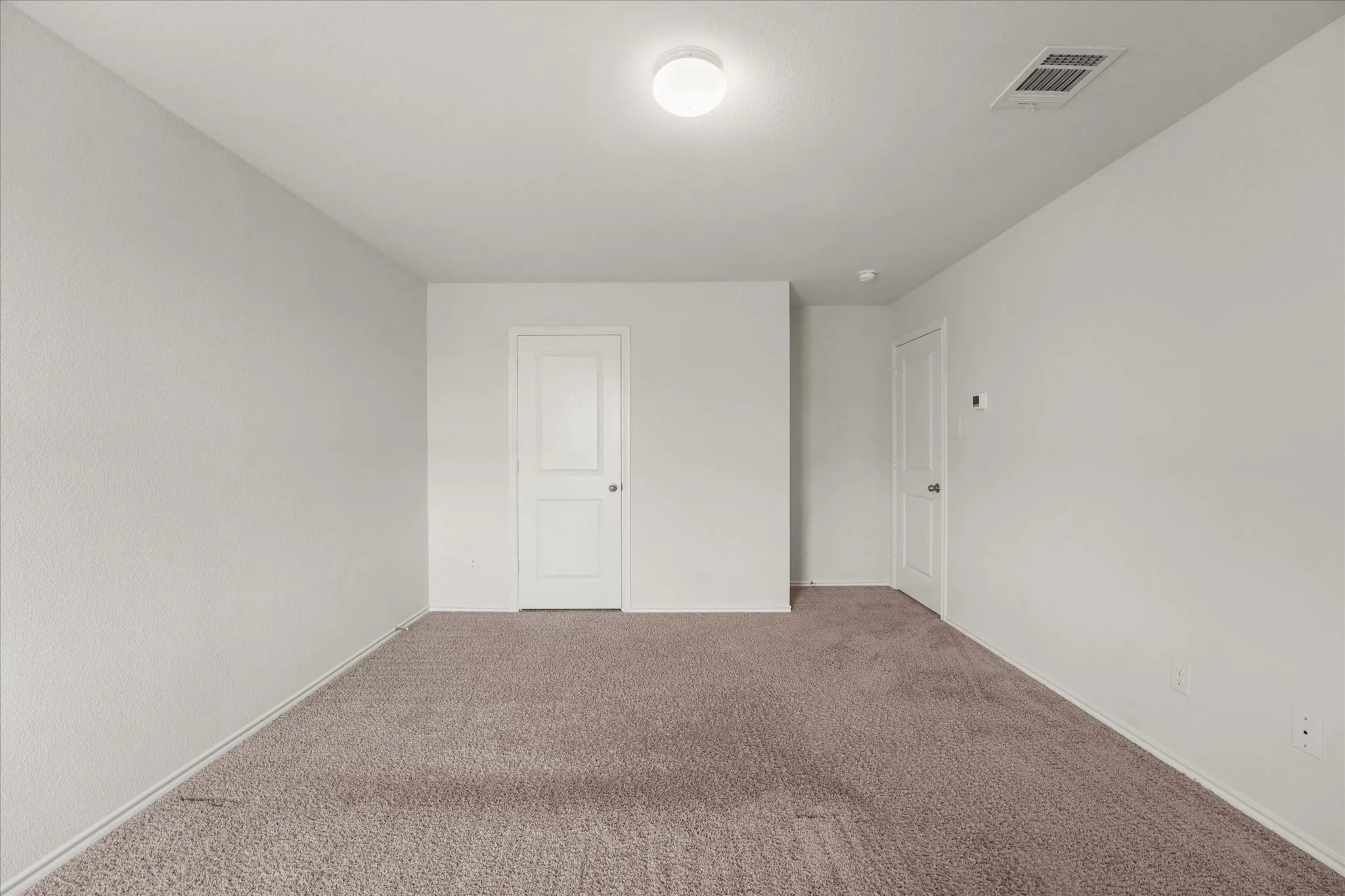 Neutral tone carpet flooring and white painted walls