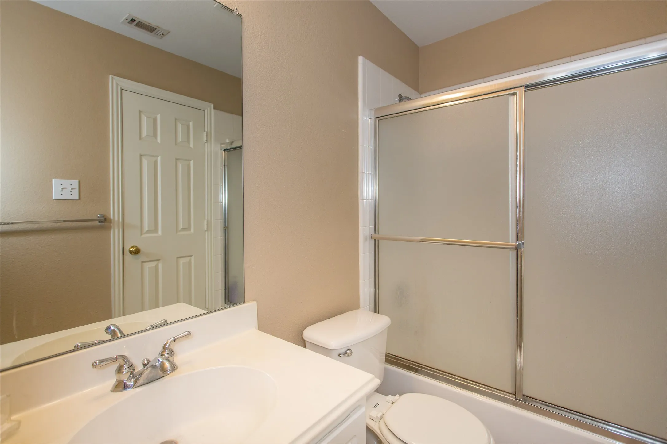 Bathroom vanity with integrated sink, chrome faucet, and full-width mirror