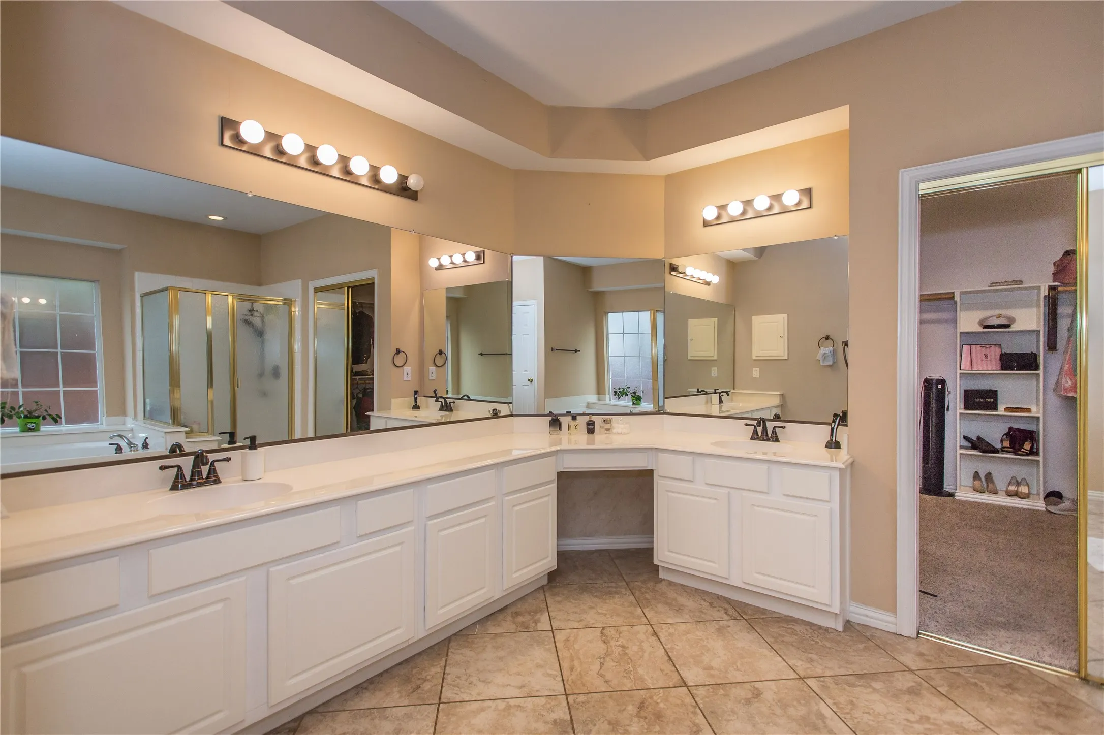 Dual vanity with white cabinetry and integrated sinks