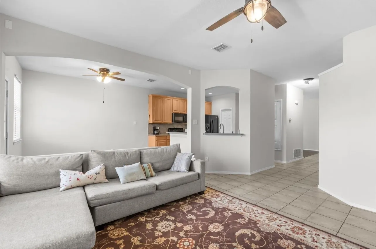 Tile flooring, arched doorways, kitchen pass-through window, ceiling fans