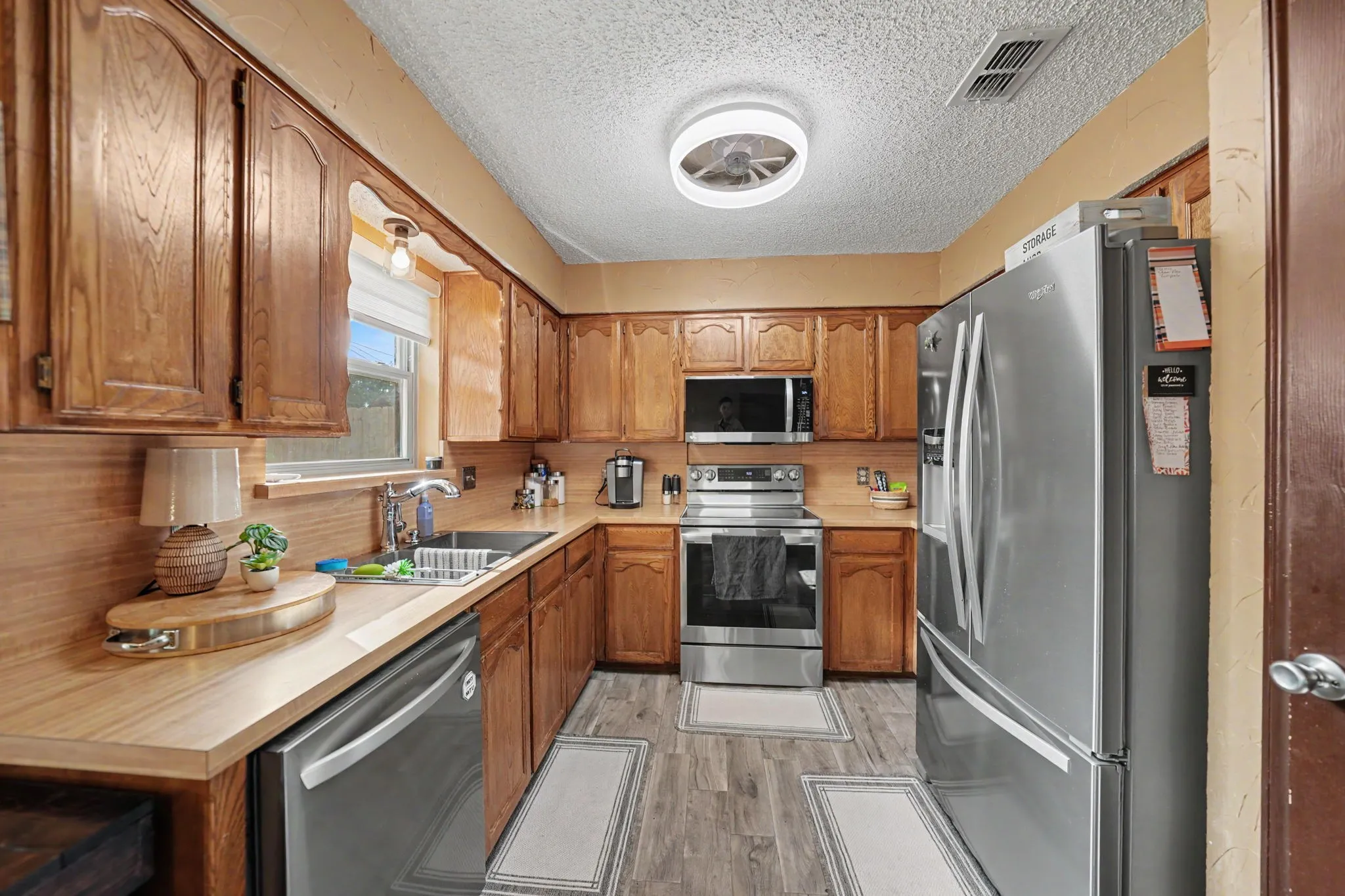 Wood-finish cabinetry paired with light countertops