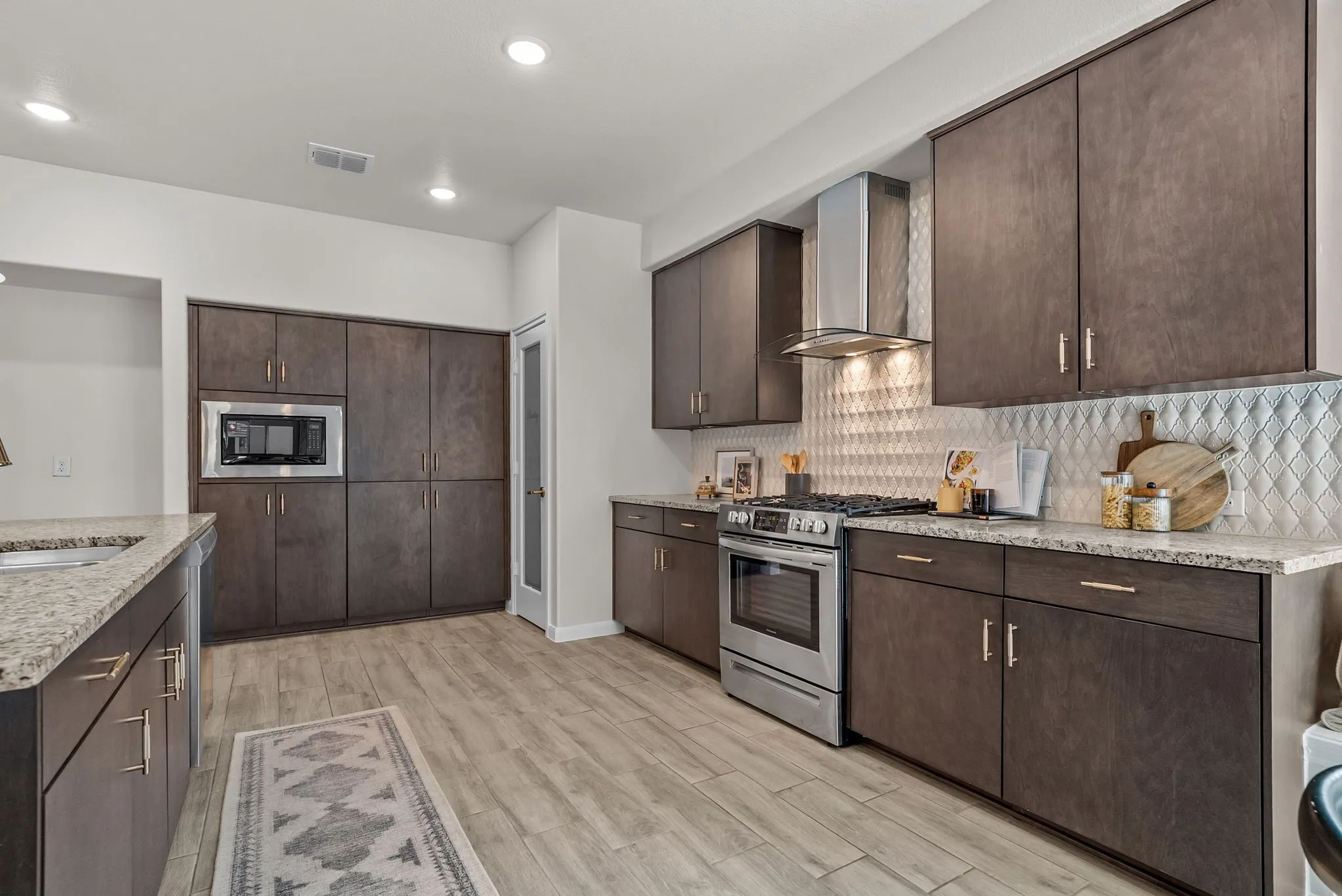 Chic flat panel cabinets, tile backsplash, and granite countertops