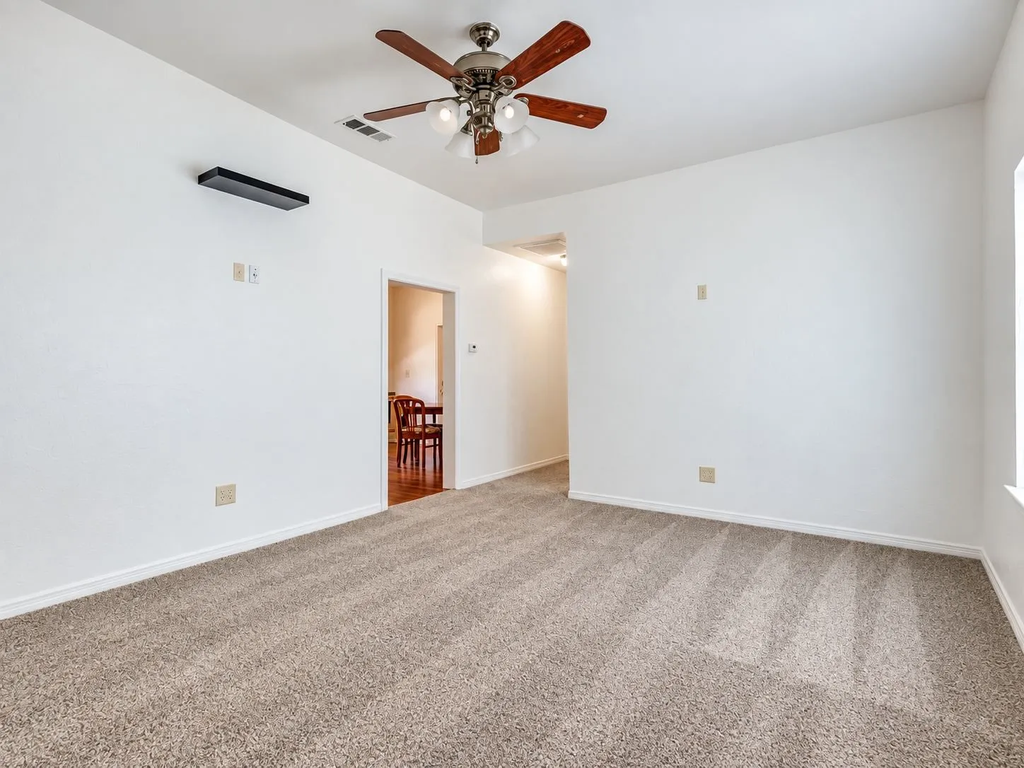 Neutral tone wall color, ceiling fan with wood-finish blades, recessed lighting, and carpet flooring