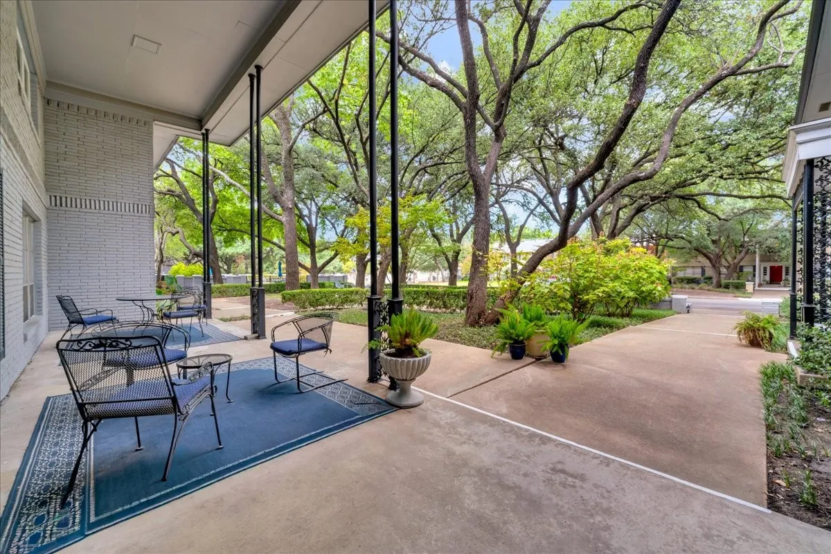 Covered outdoor patio with a concrete surface and structural pillars