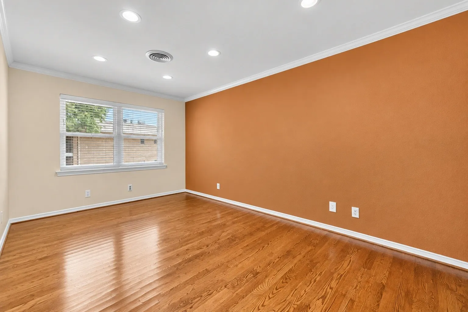 Hardwood flooring, recessed lighting, crown molding, white trim, and a window with blinds