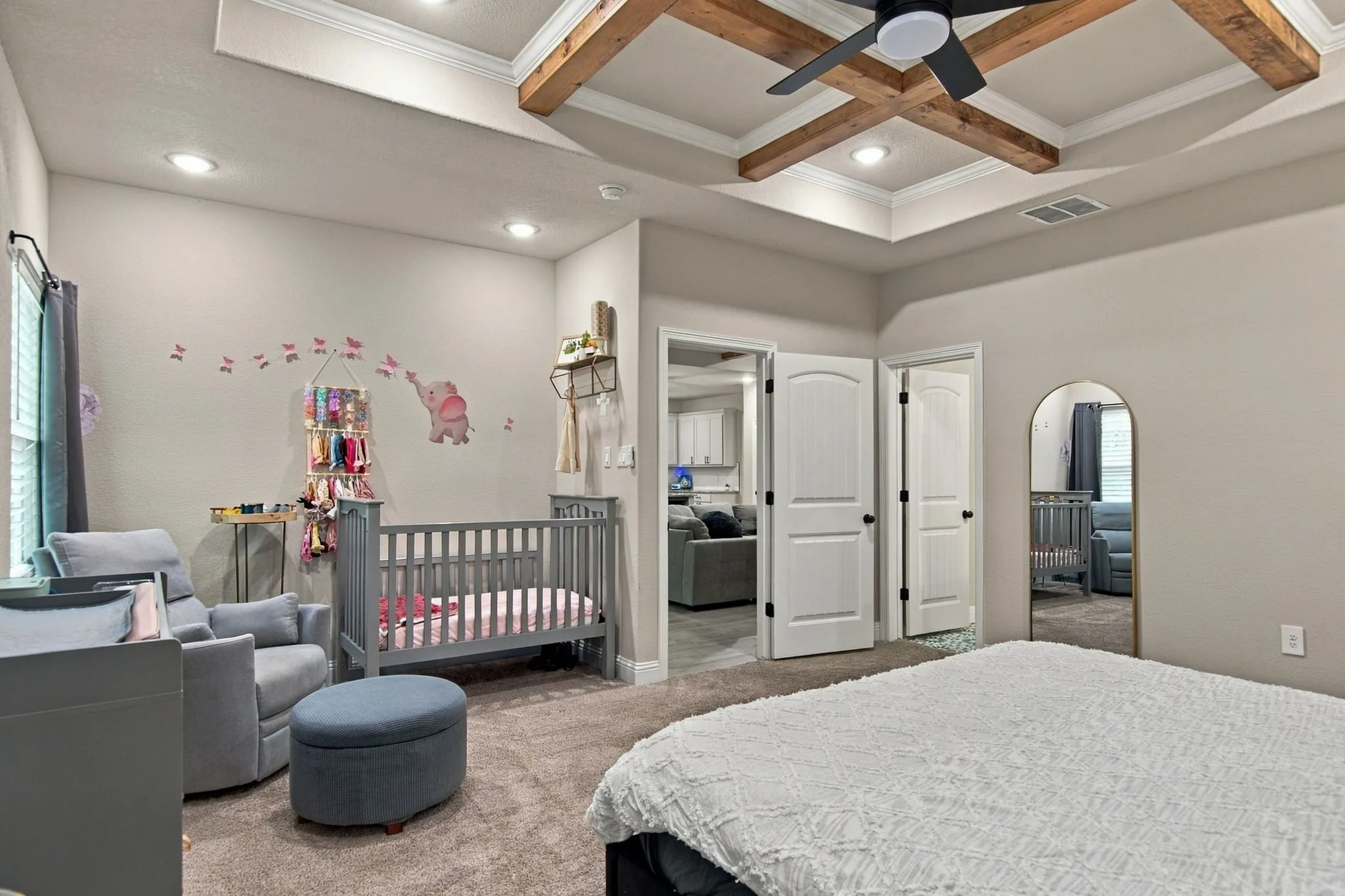 Tray ceiling with exposed wood beams and recessed lighting