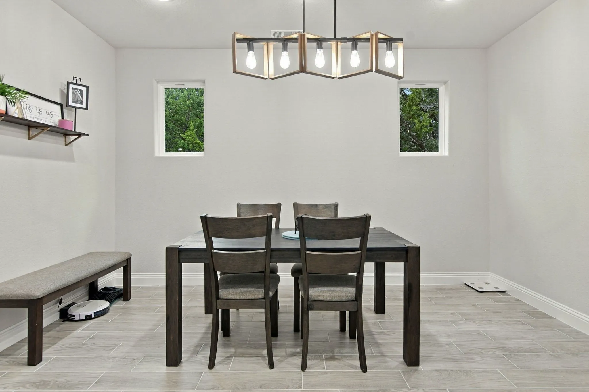 Recessed lighting highlights a modern chandelier with exposed bulbs