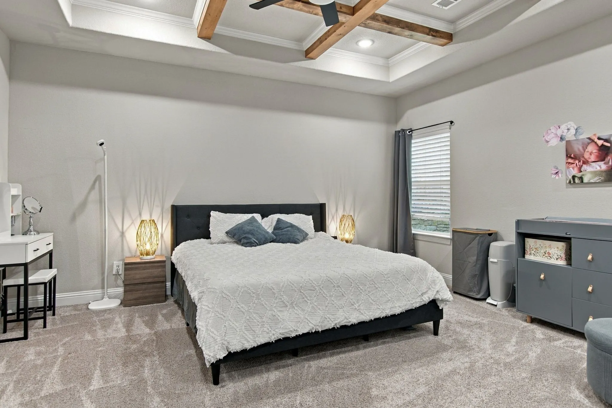 Tray ceiling with wood-finish beams and a ceiling fan