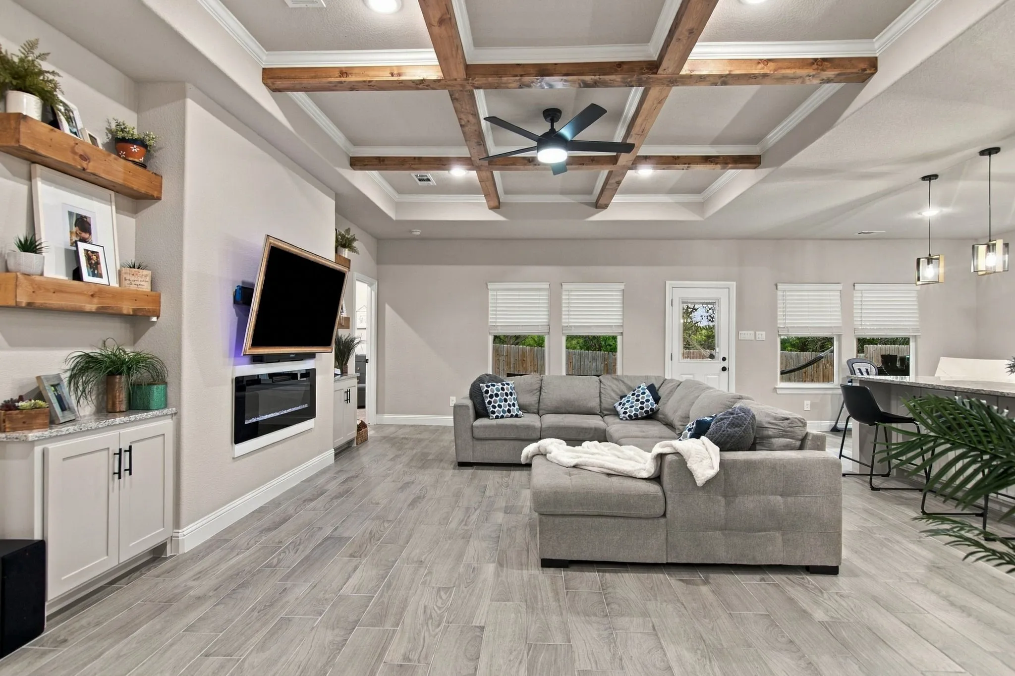 Coffered ceiling with exposed wood beams and recessed lighting